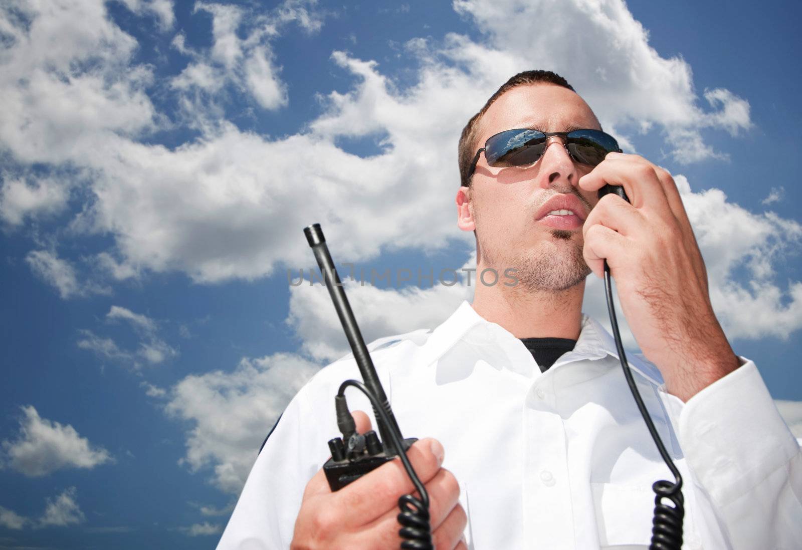 Security guard using hand-held radio for communication