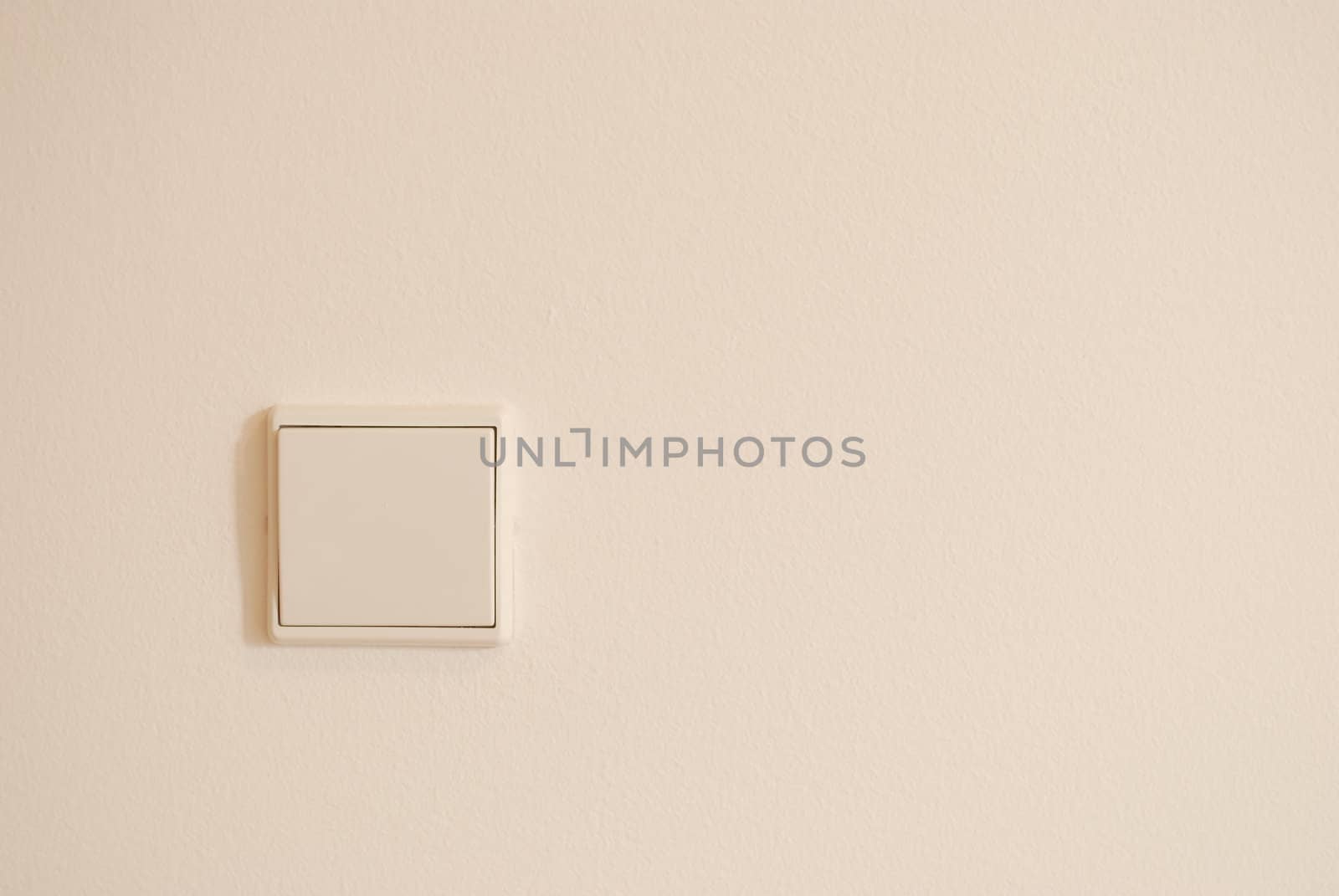 White and modern light switch on wall by luissantos84