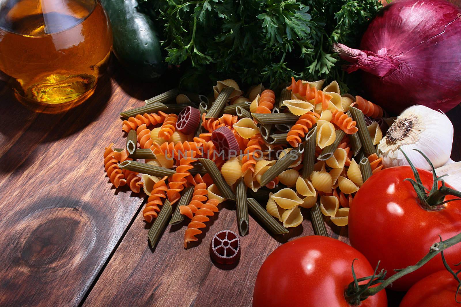 Figured colour vermicelli and vegetables with vegetable oil in a transparent bottle - components for many culinary recipes.