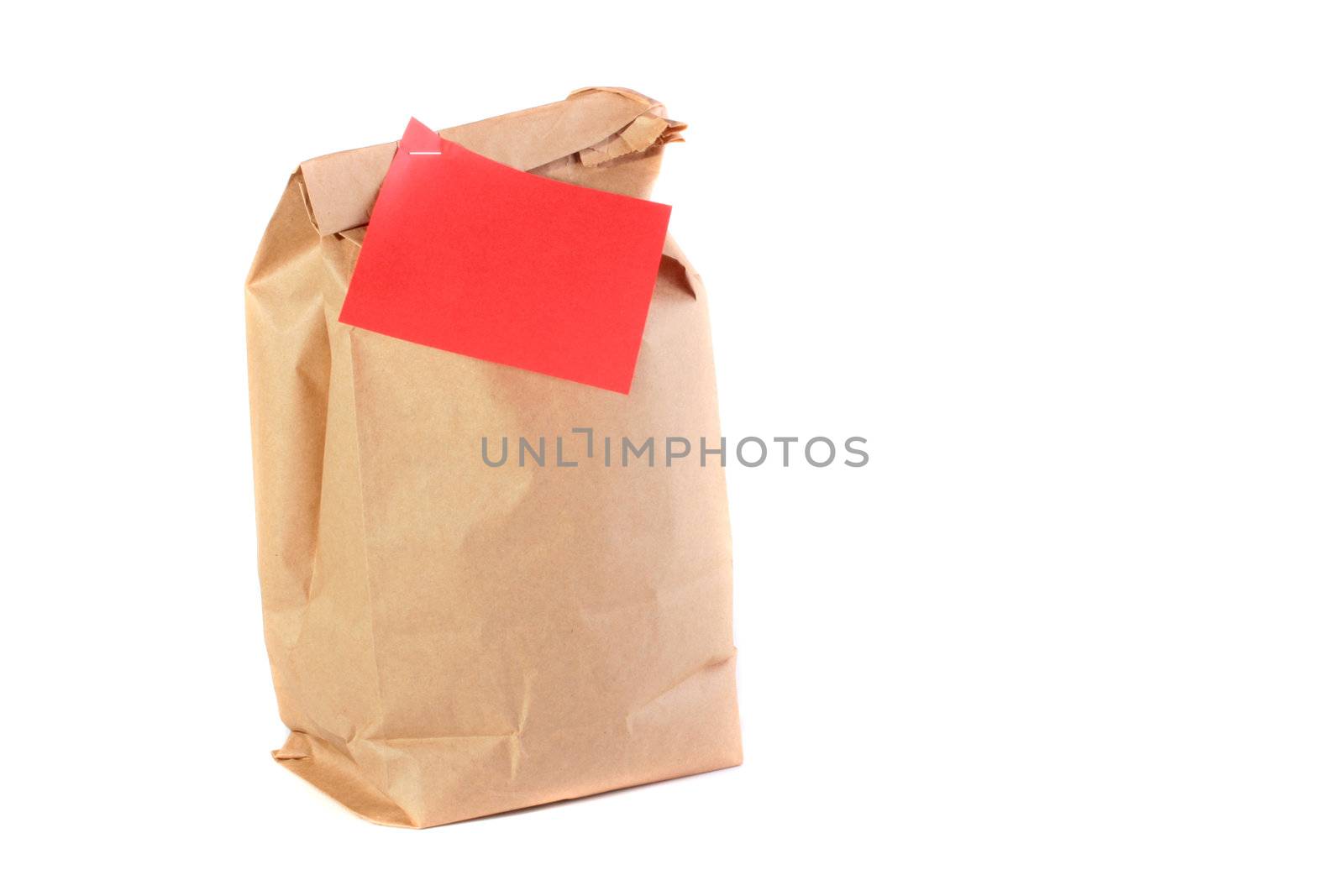 Paper packages for a dinner with the pinned red piece of paper for messages.