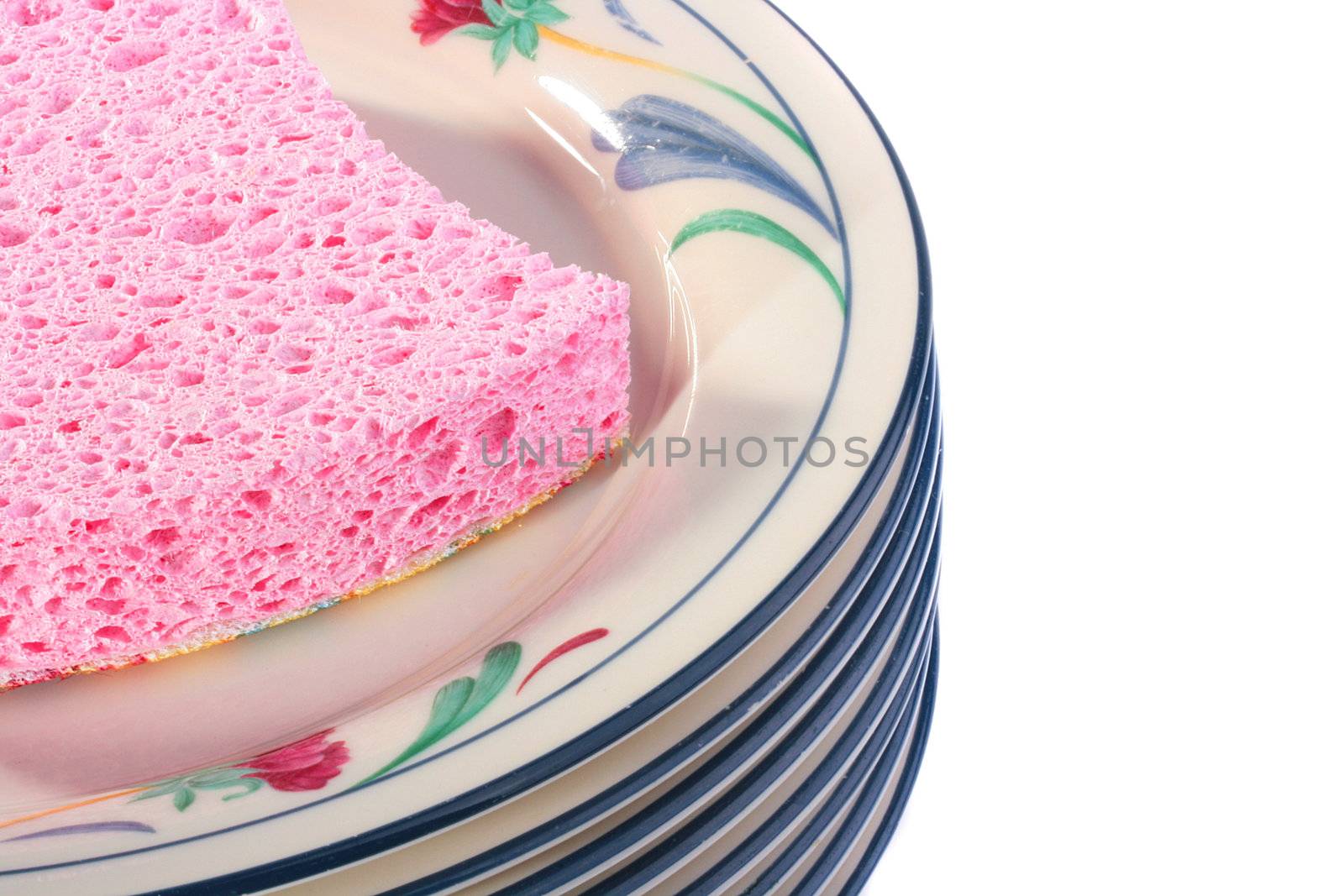 Pink bast for ware washing on a pile of pure plates.