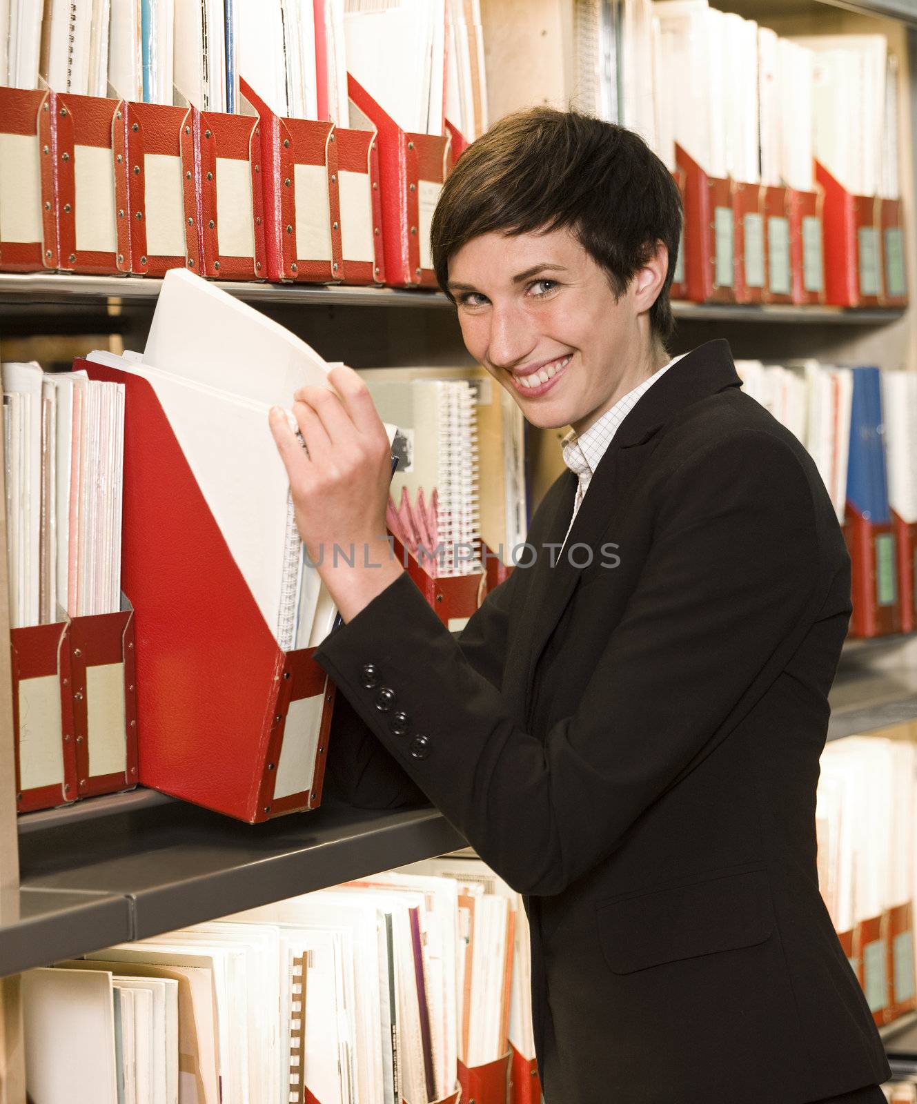 Smiling woman searching at an archive