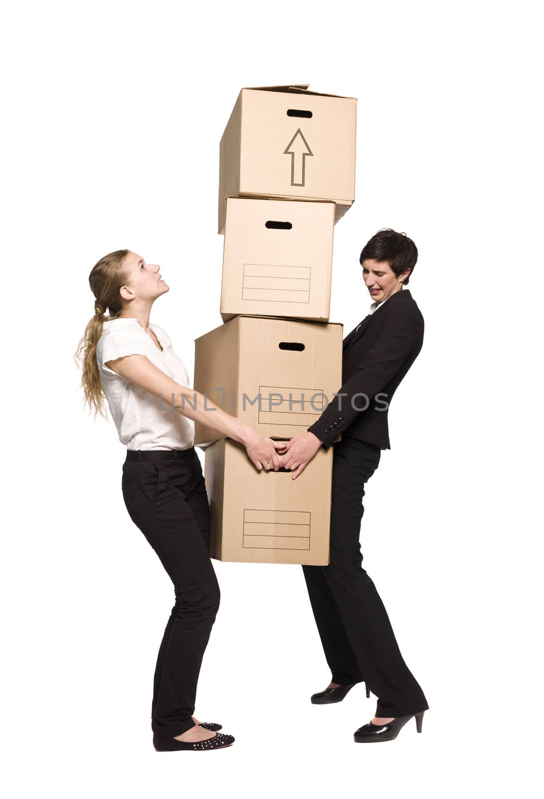 Two women carrying four boxes