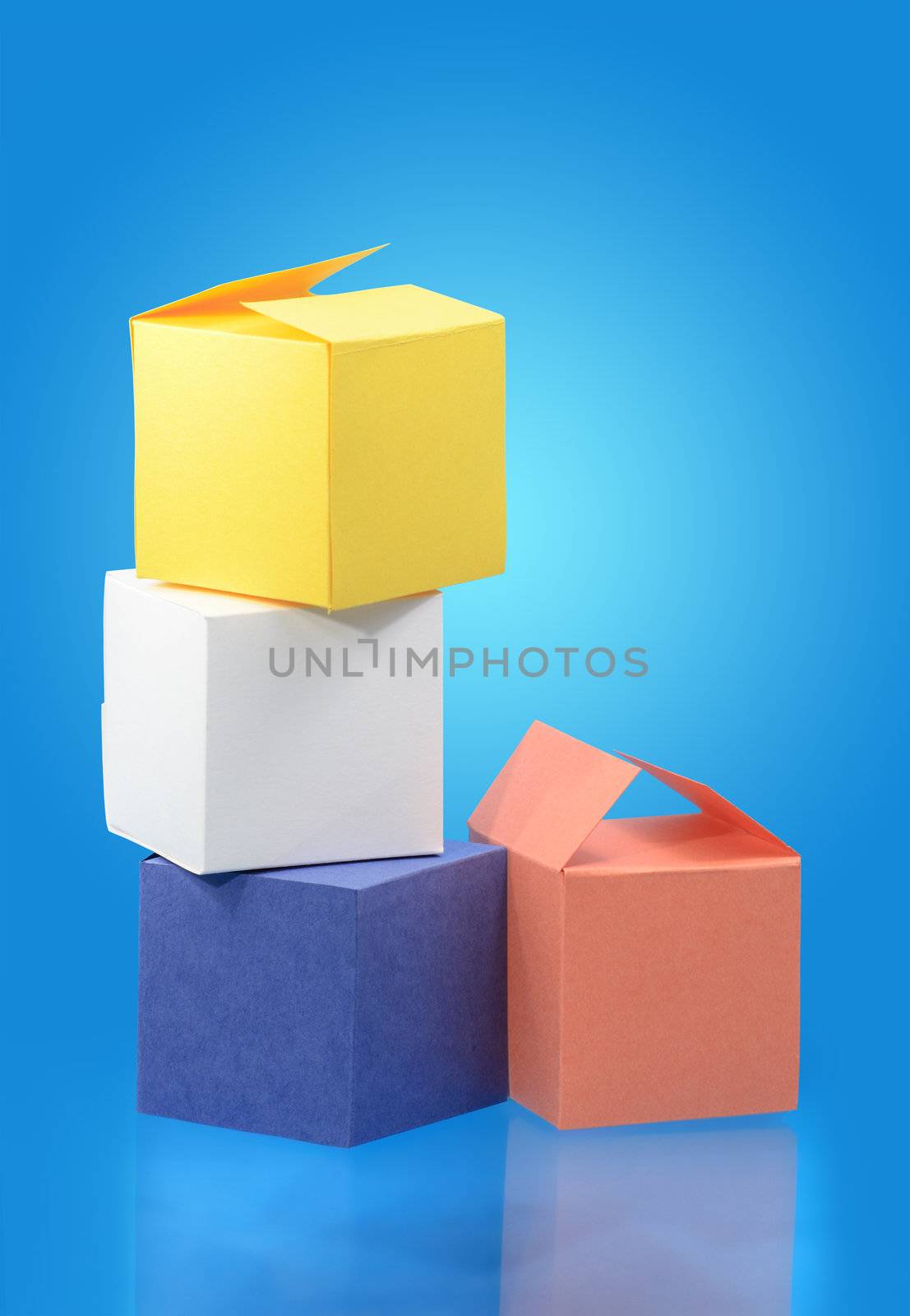 Four colored paper boxes on blue background with copy space