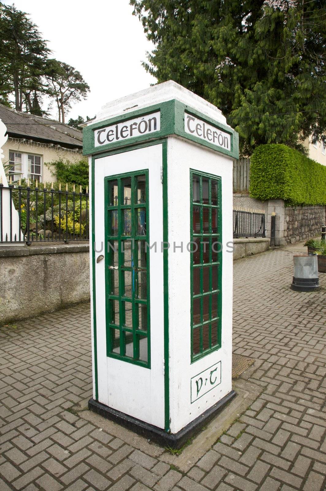 irish white and green phone box at the street
