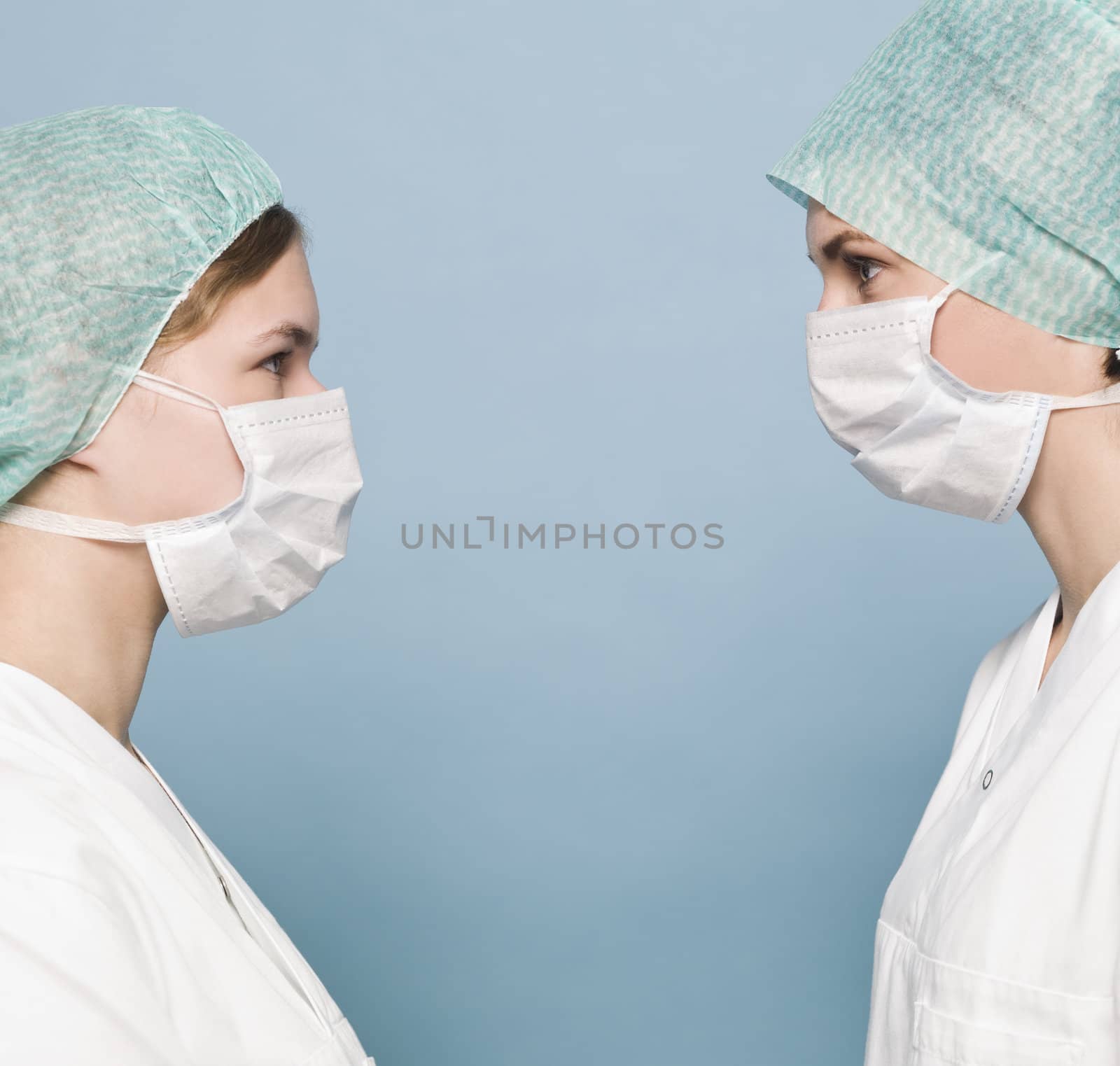 Two nurses with surgical masks by gemenacom