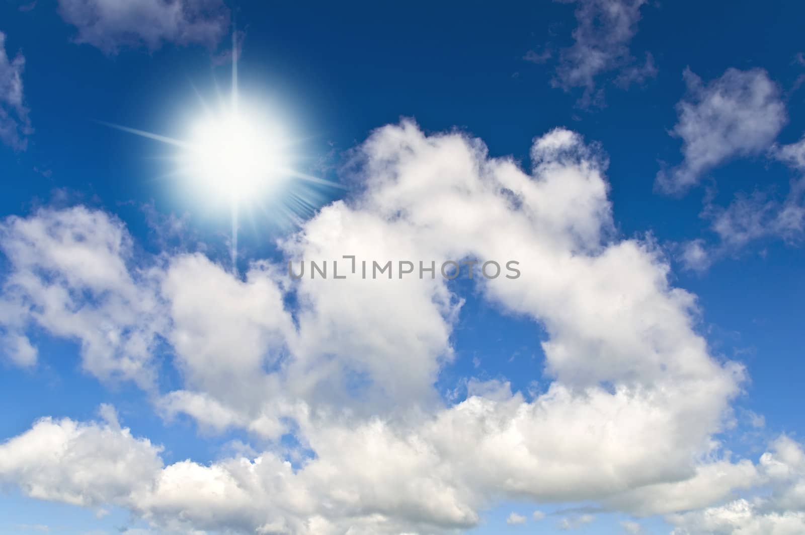 Sun in bright blue sky. Cloudscape