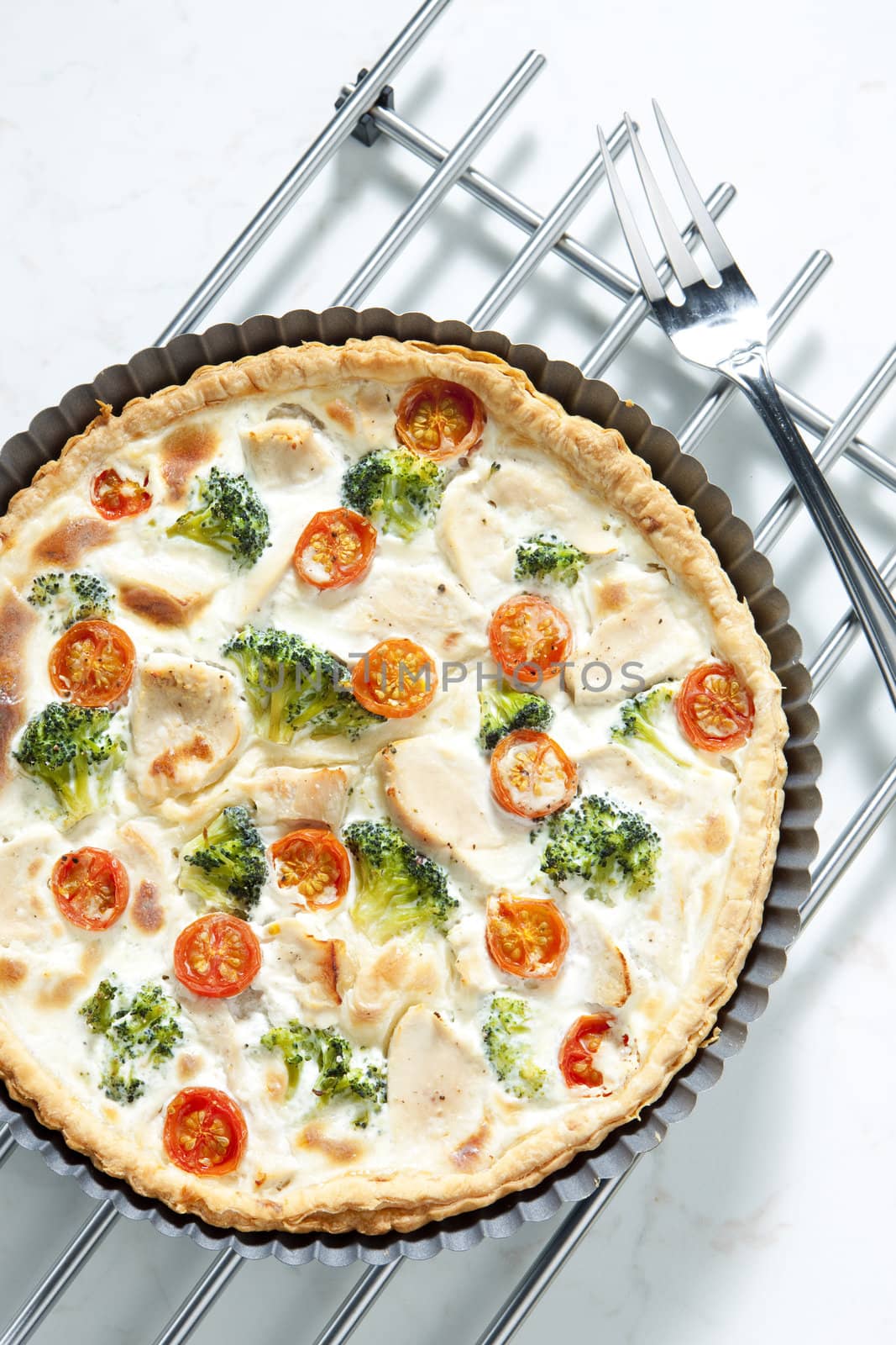 cake with broccoli, cherry tomatoes and chicken meat
