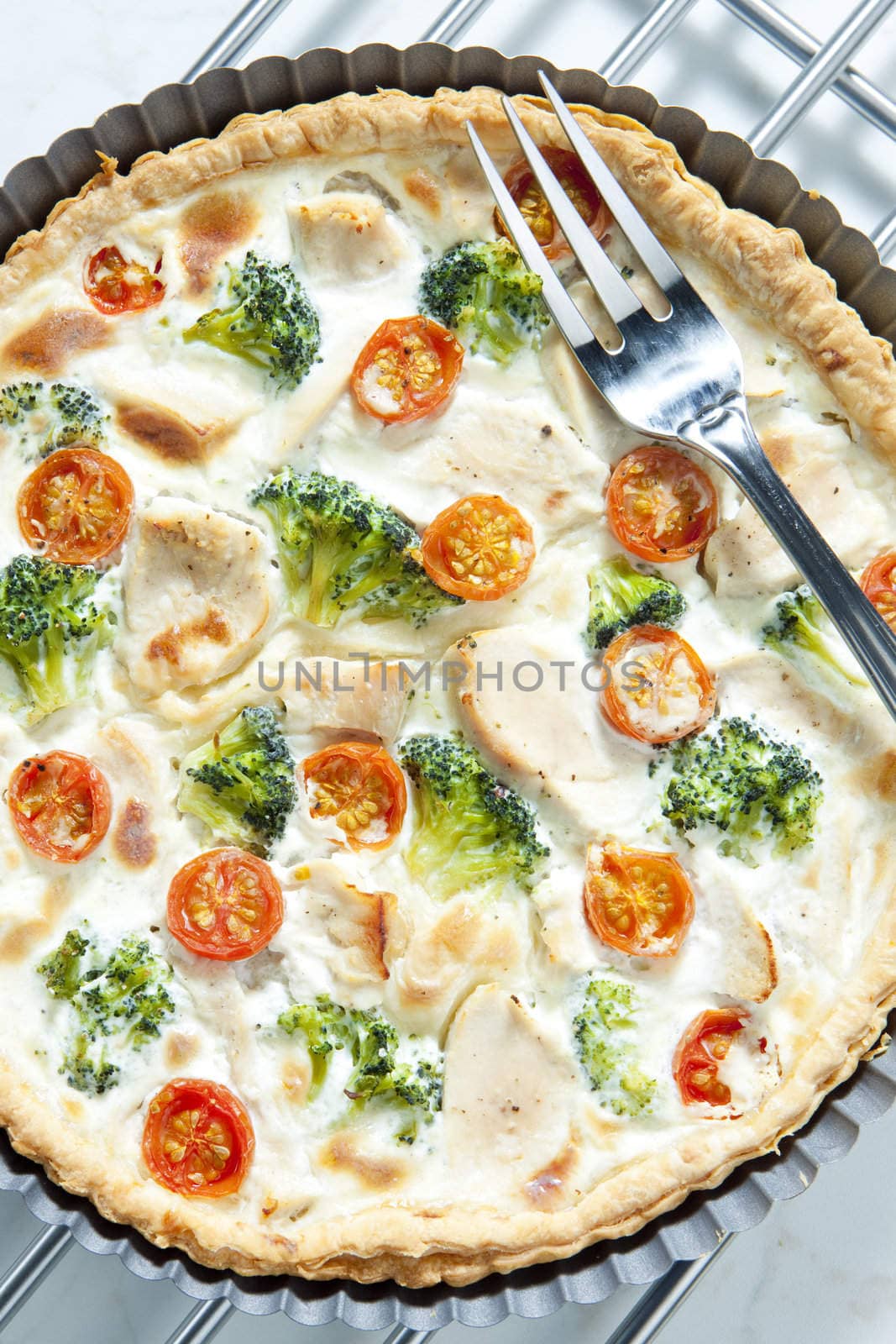 cake with broccoli, cherry tomatoes and chicken meat