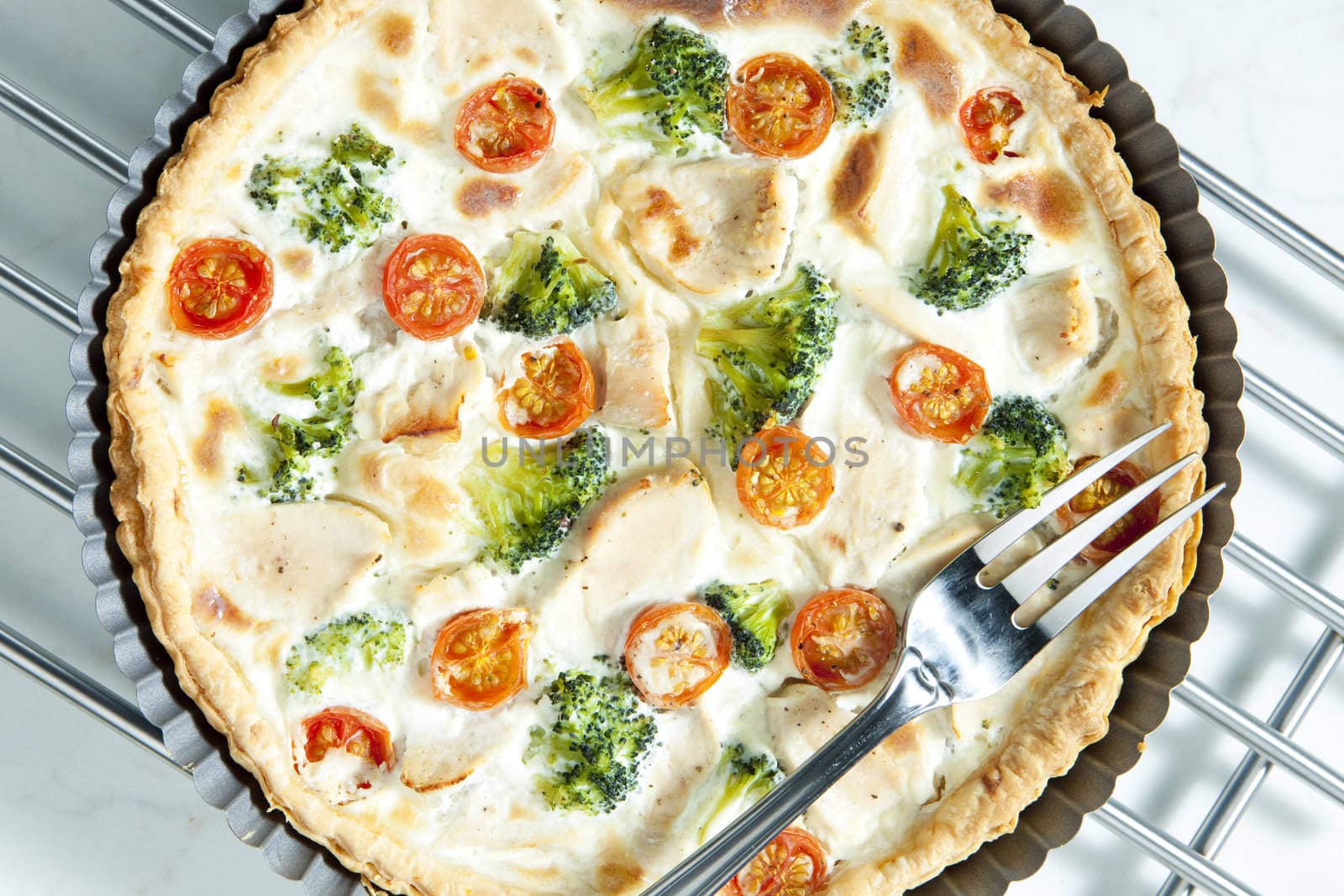cake with broccoli, cherry tomatoes and chicken meat