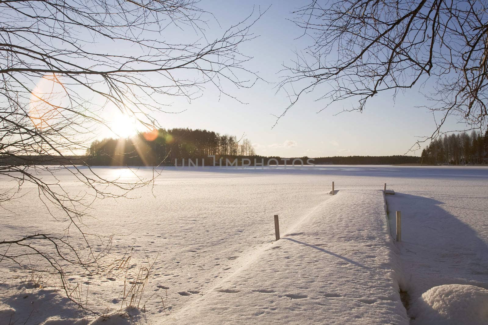 Wide view over the frozen lake on a sunny winter day.