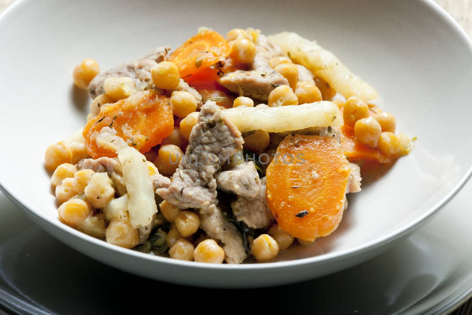 pork meat on celery with carrot and chick peas