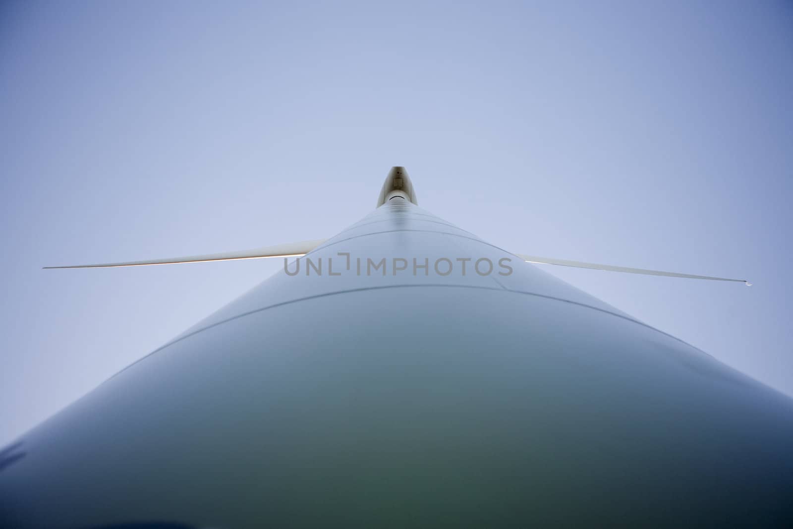 Closeup picture of a modern windmill producing renewable energy ecologically.