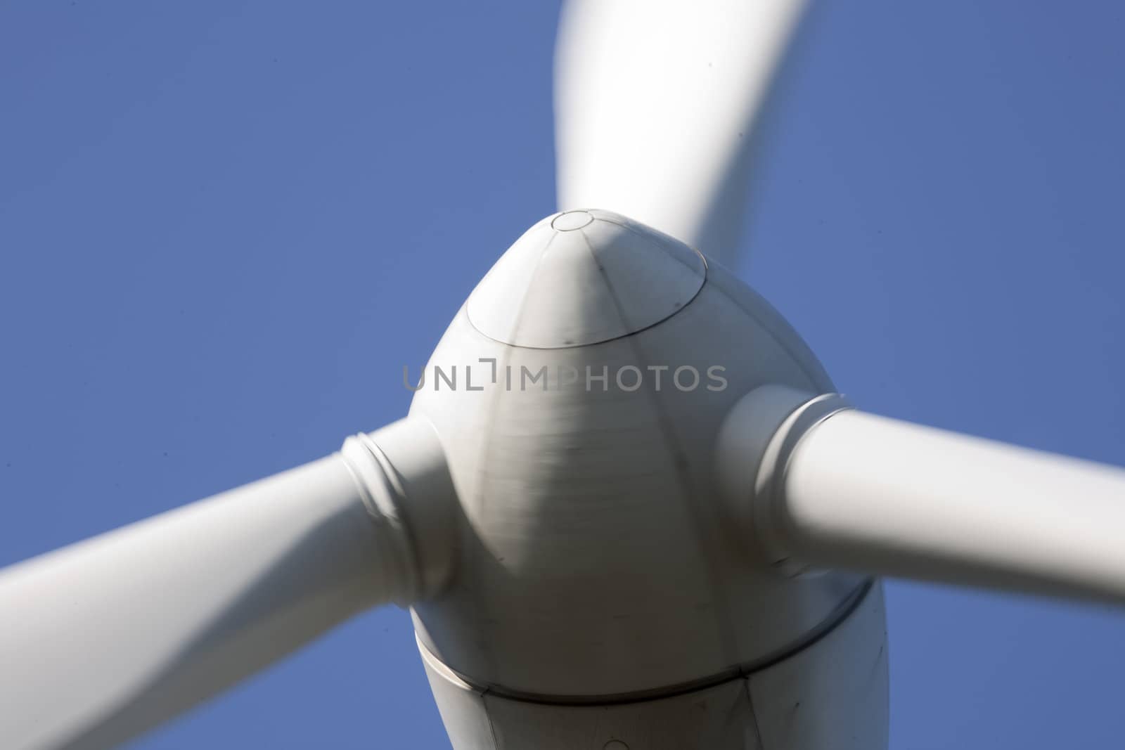 Modern windmill producing renewable energy ecologically.