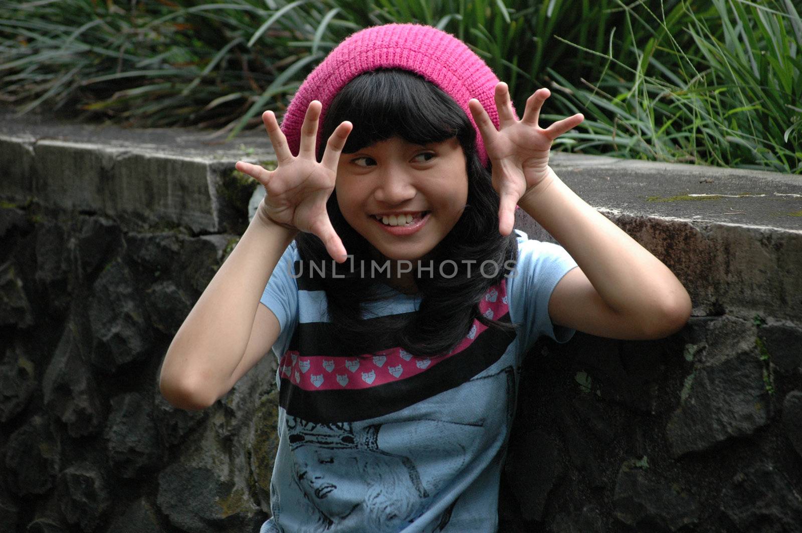 cute asian girl wearing pink hat