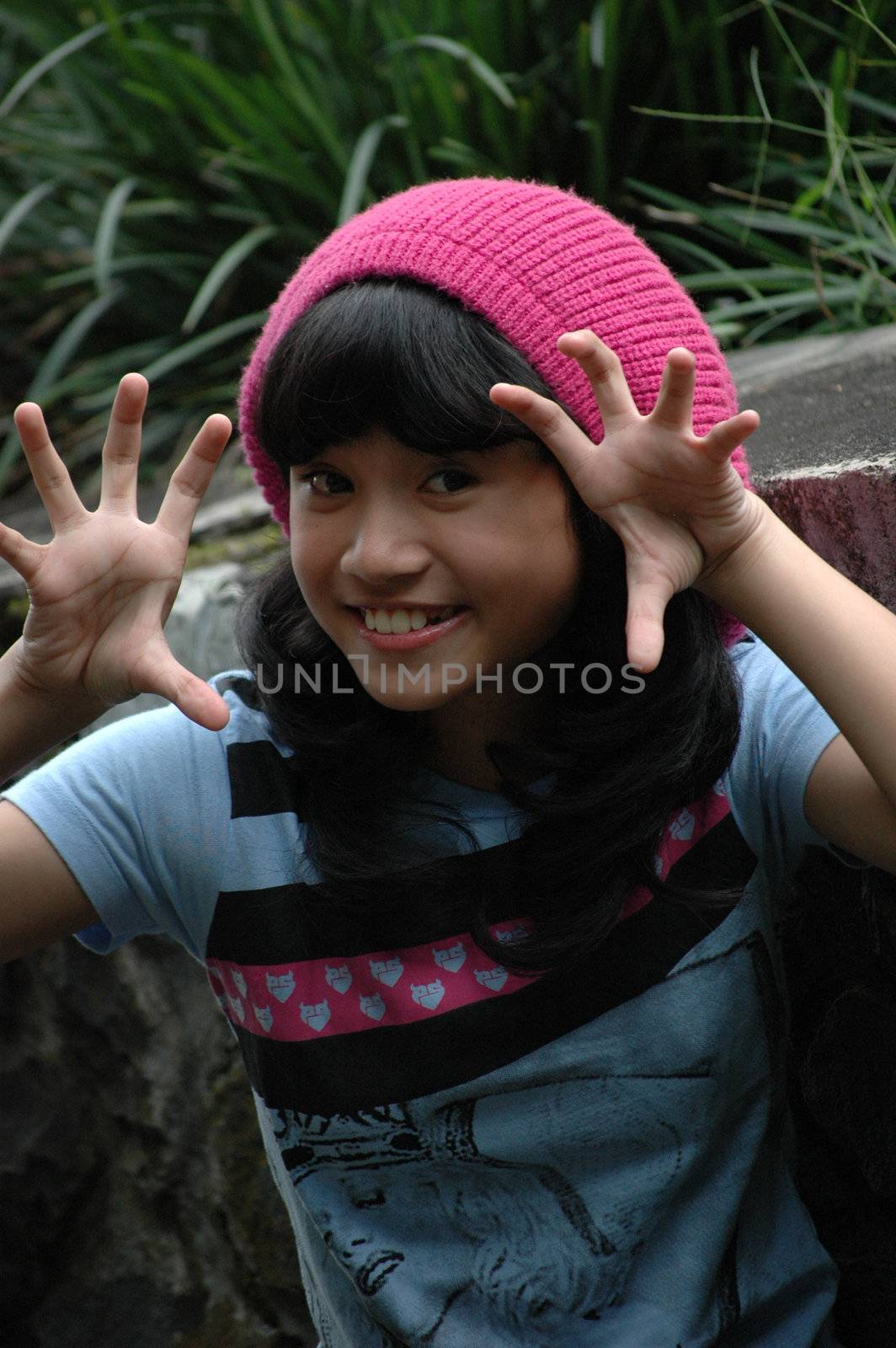 cute asian girl wearing pink hat