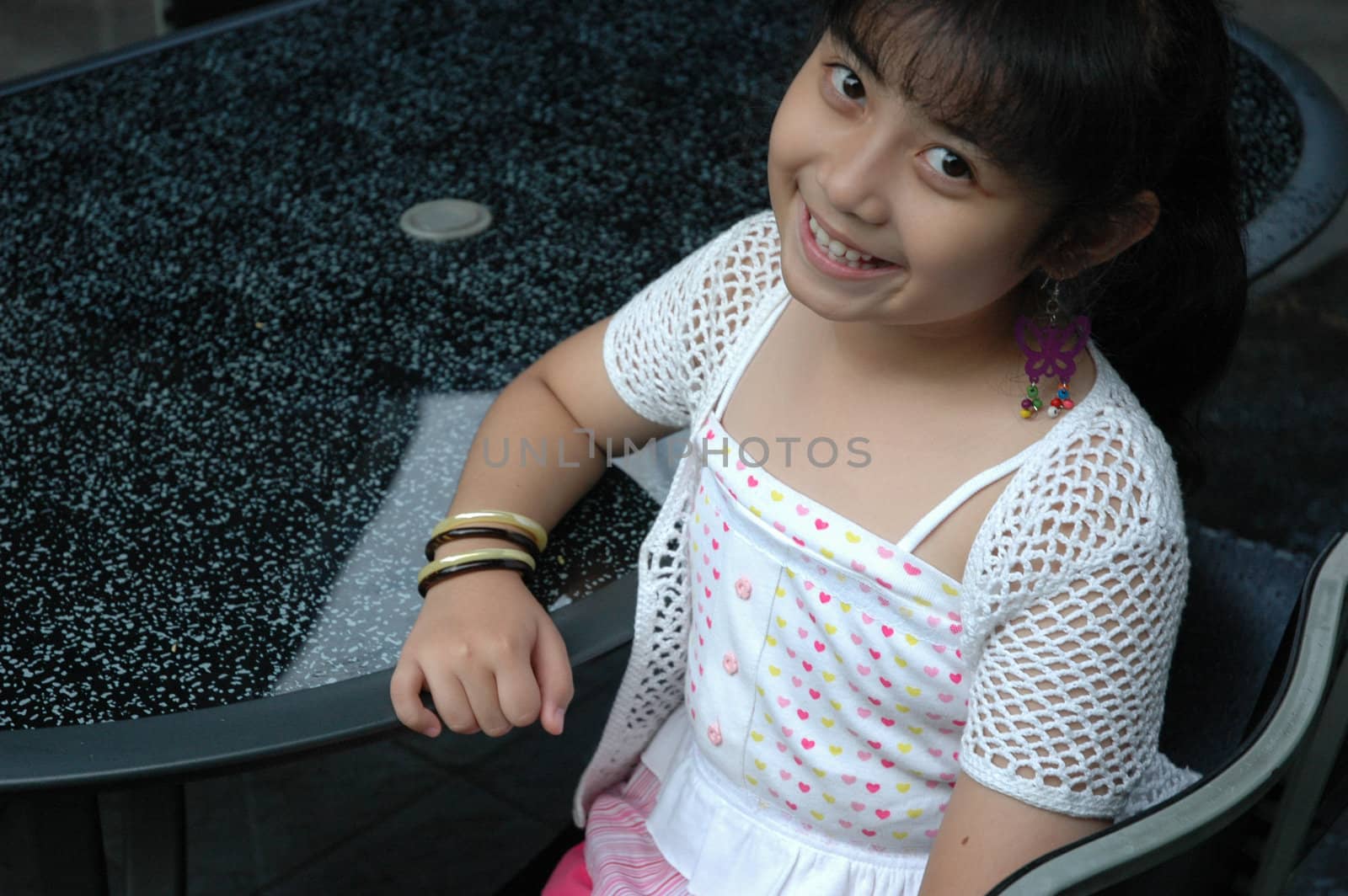 little asian girl sit down in chair