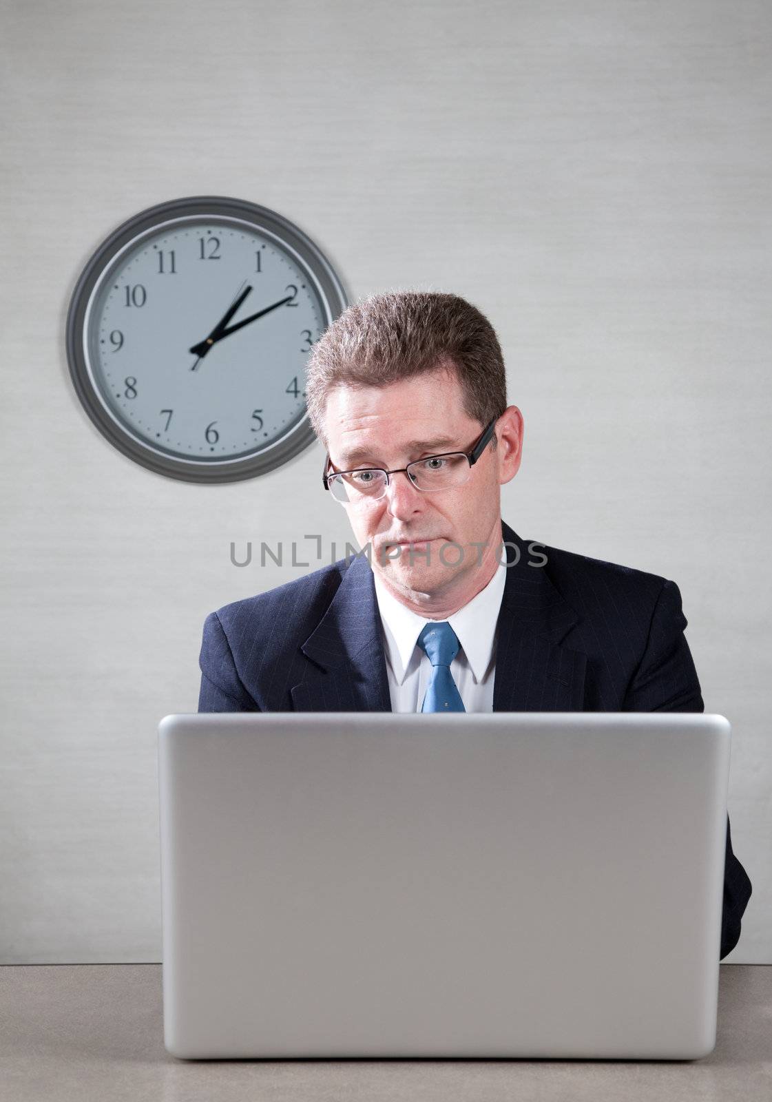 Bored businessman working on a laptop computer