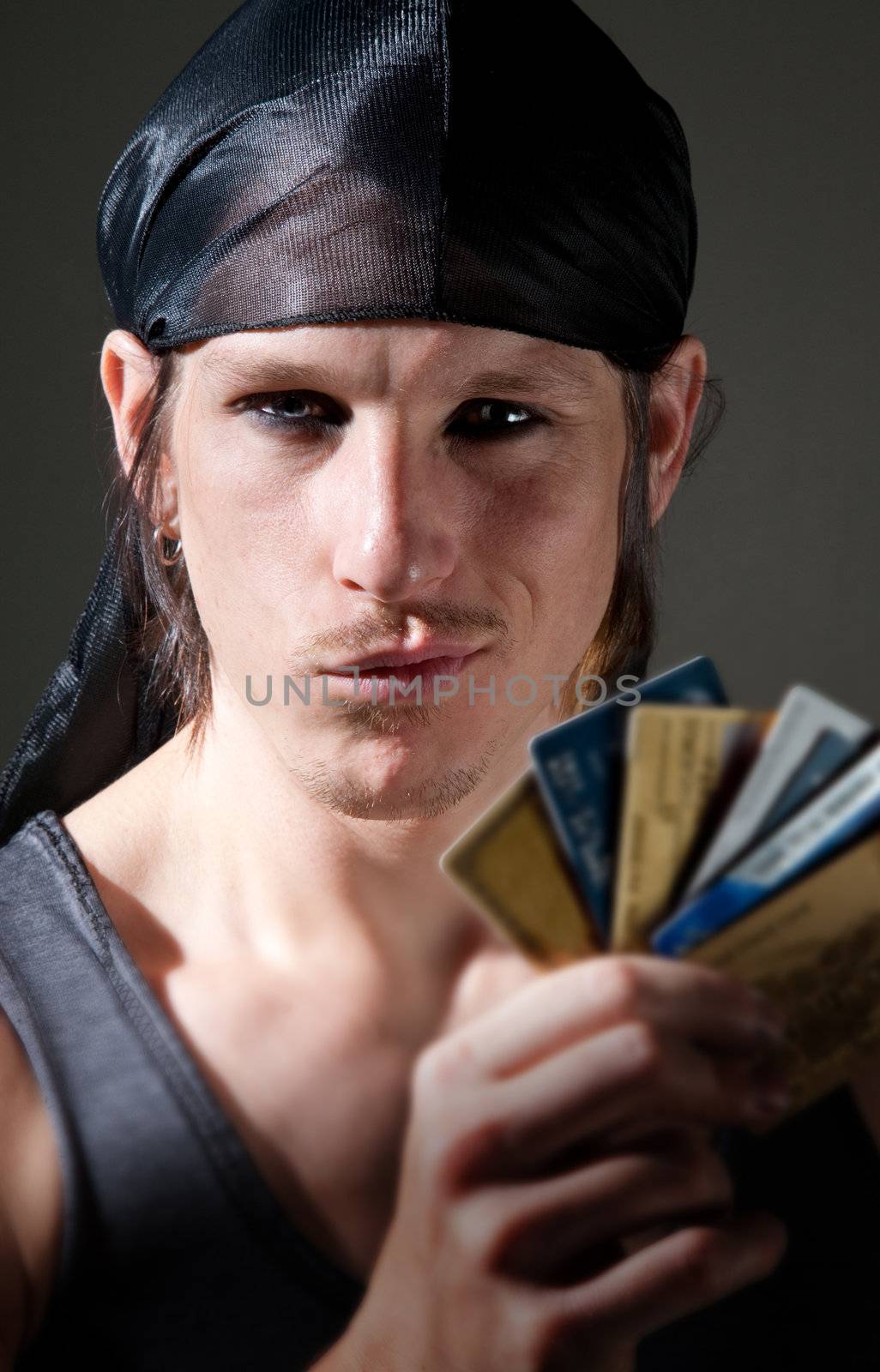 Thief with many stolen credit cards in his hand
