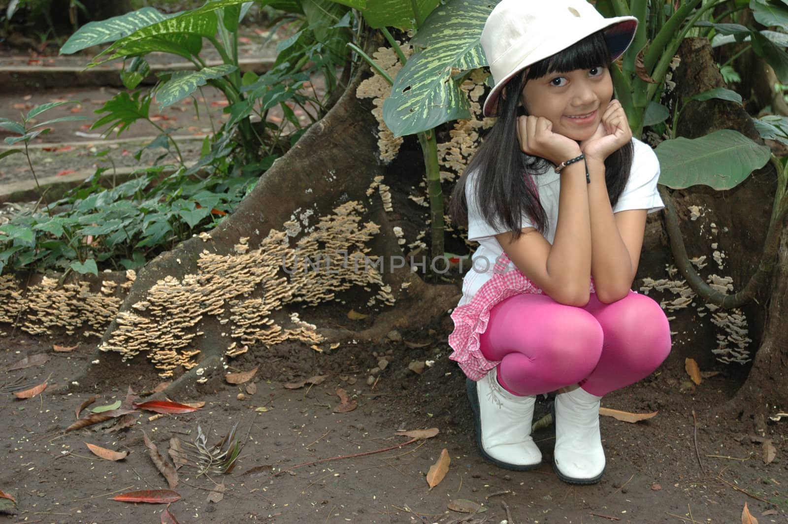 little asian girl sit down in park