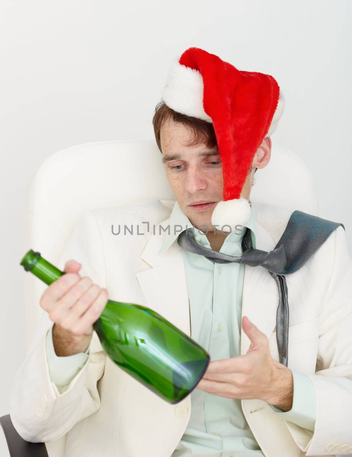 The young drunkard celebrates new year with a wine bottle