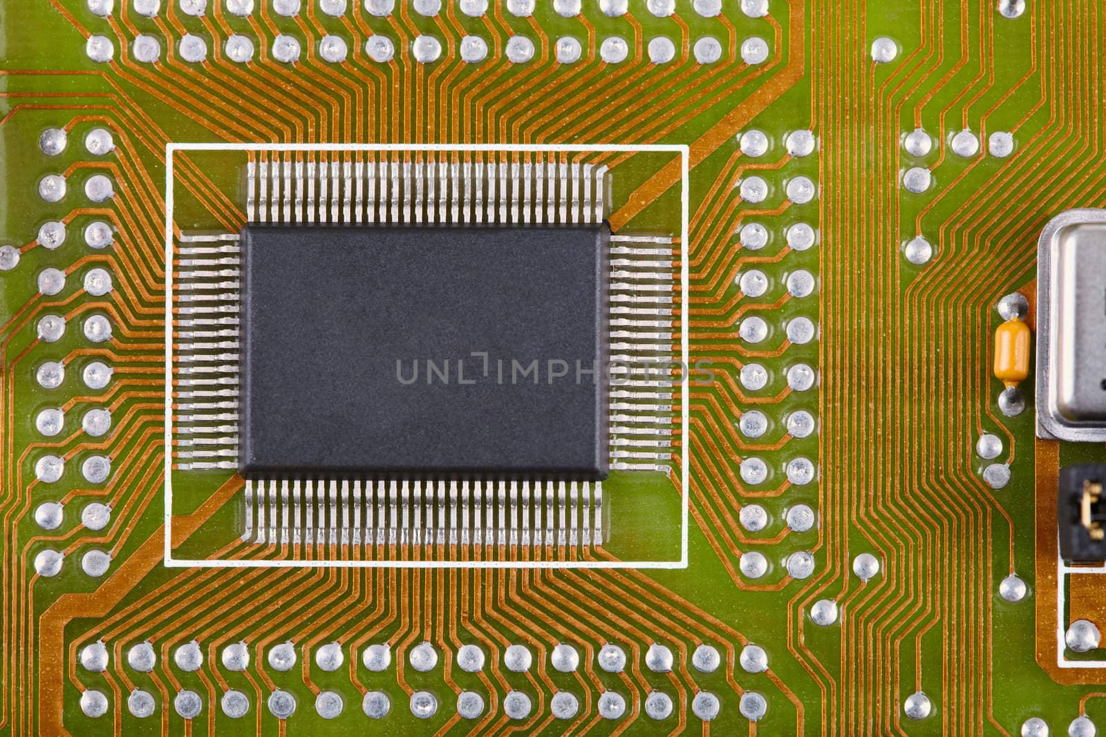 Small microcircuit soldered to an electronic plate near to other components
