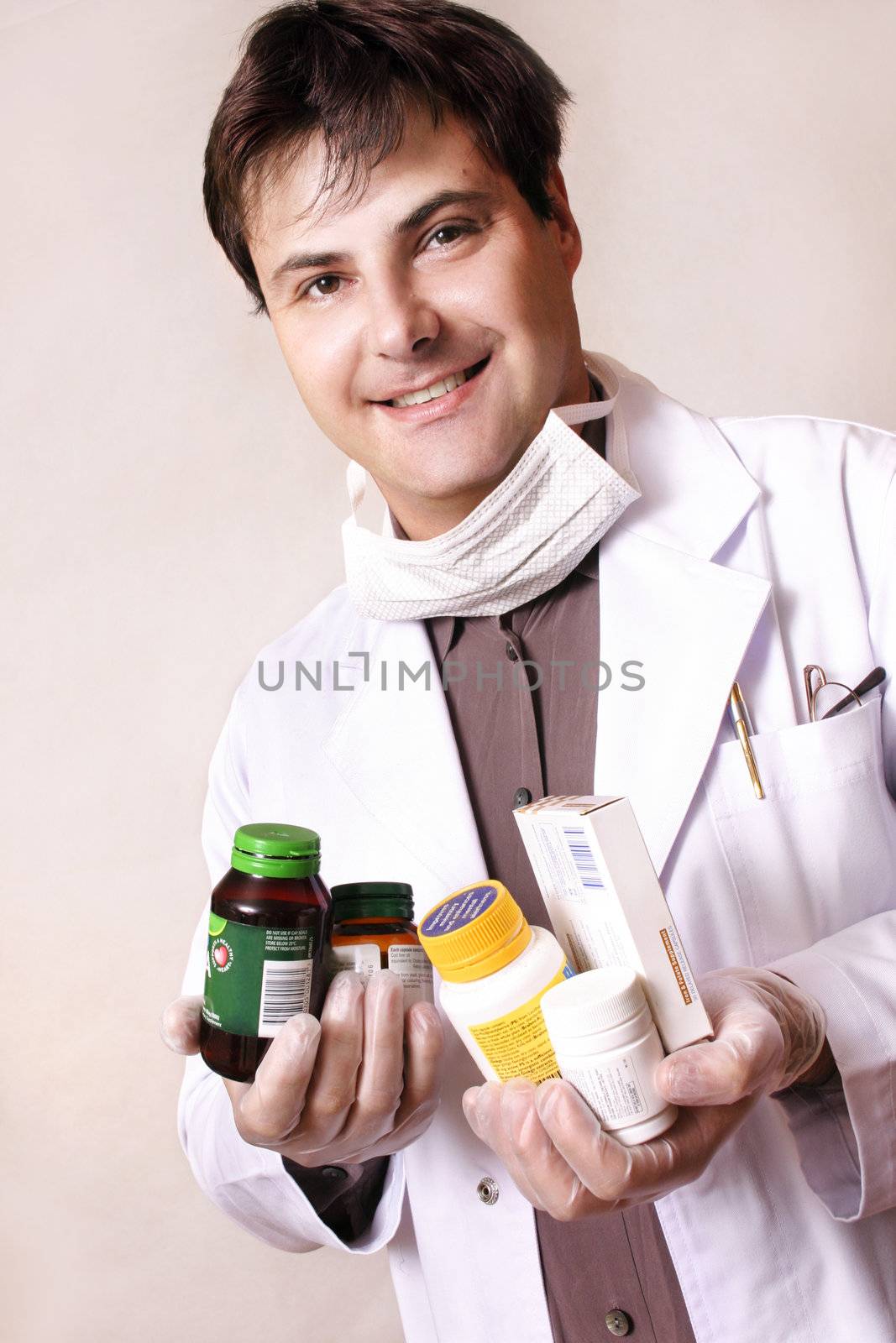 Doctor holding a variety of medicines and supplements