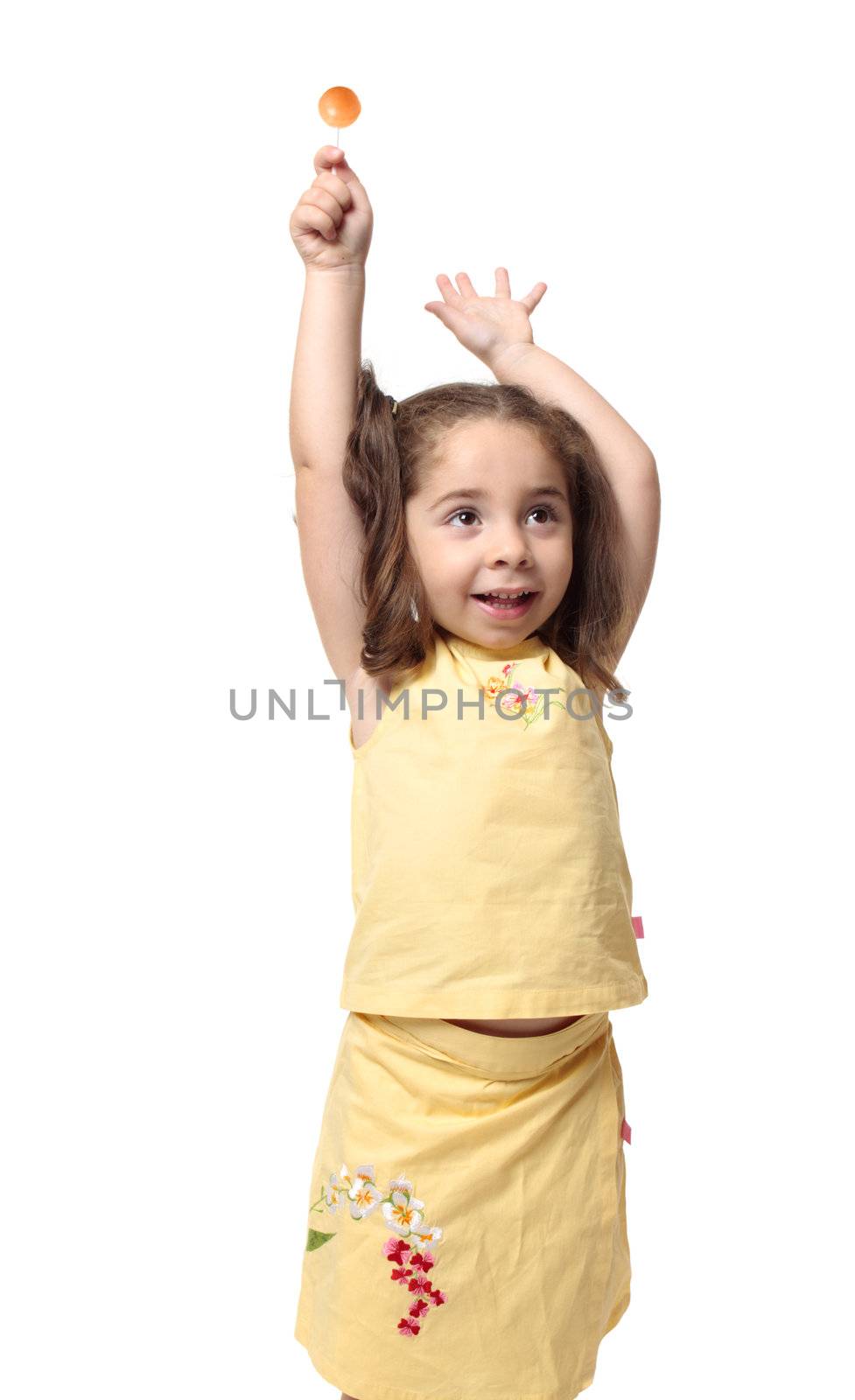 Playful girl holding a sweet lollipop candy on a stick