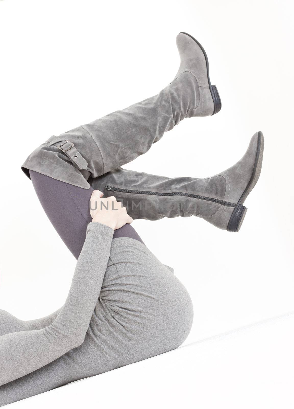 detail of lying woman wearing fashionable gray boots