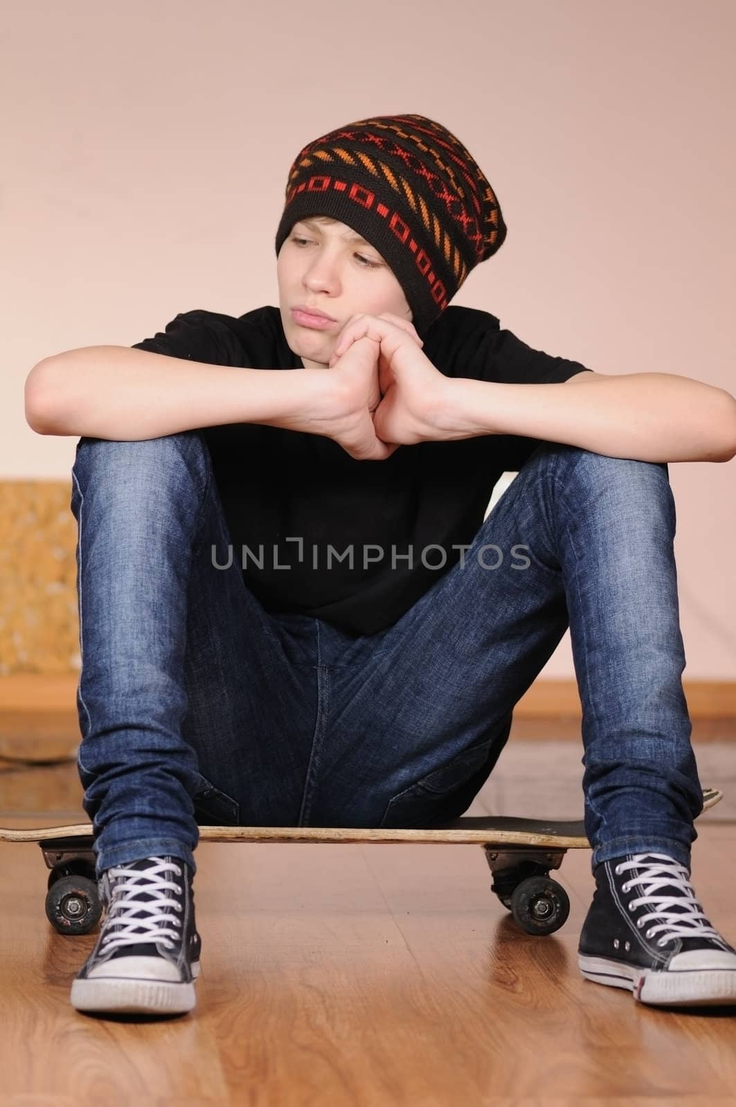 The teenager with a skateboard and in a hat