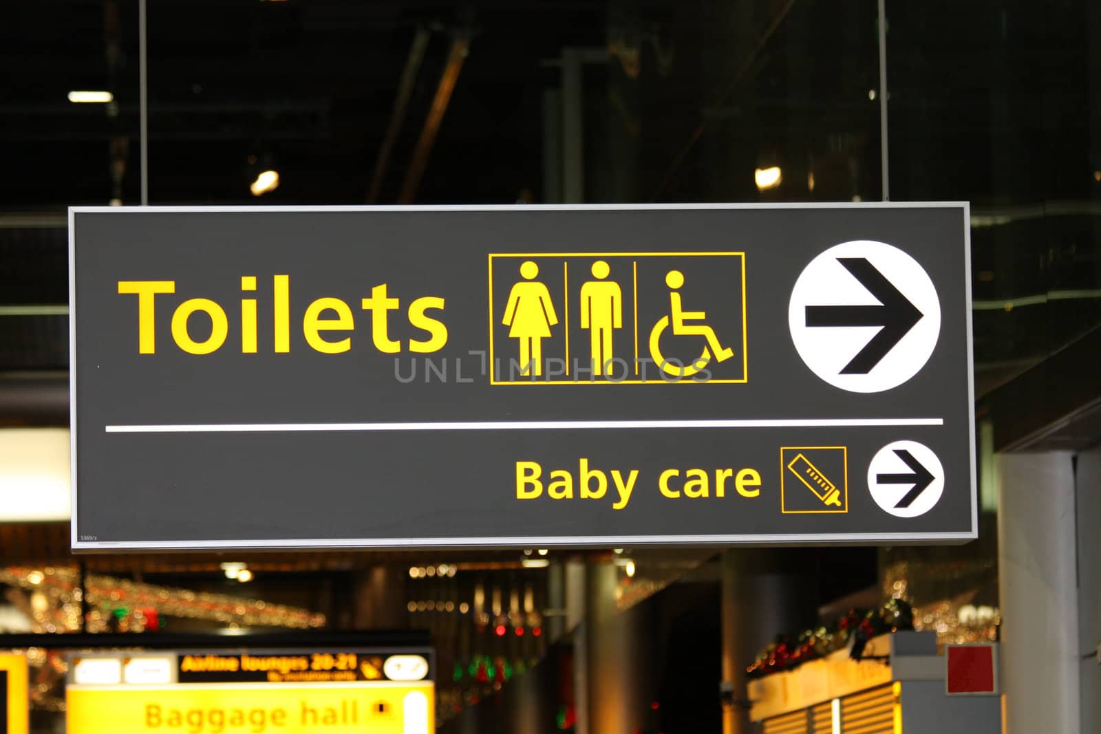 An airport information sign about toilets and baby care