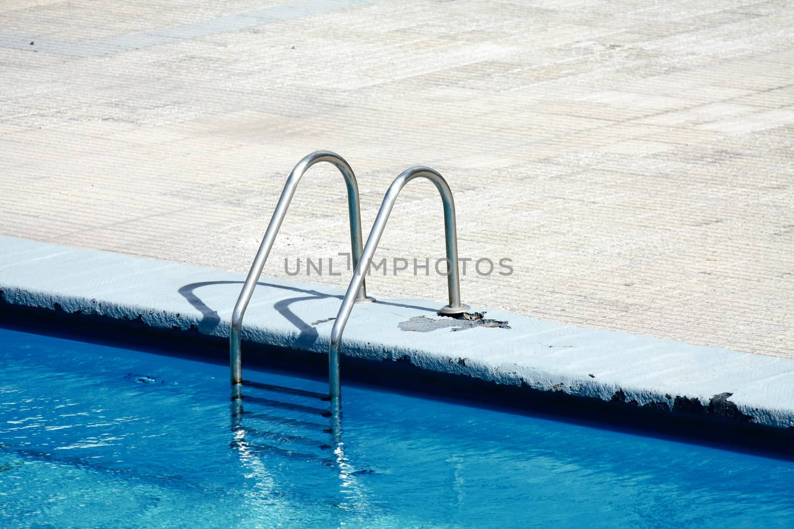 A metal ladder on the side of a swimming pool