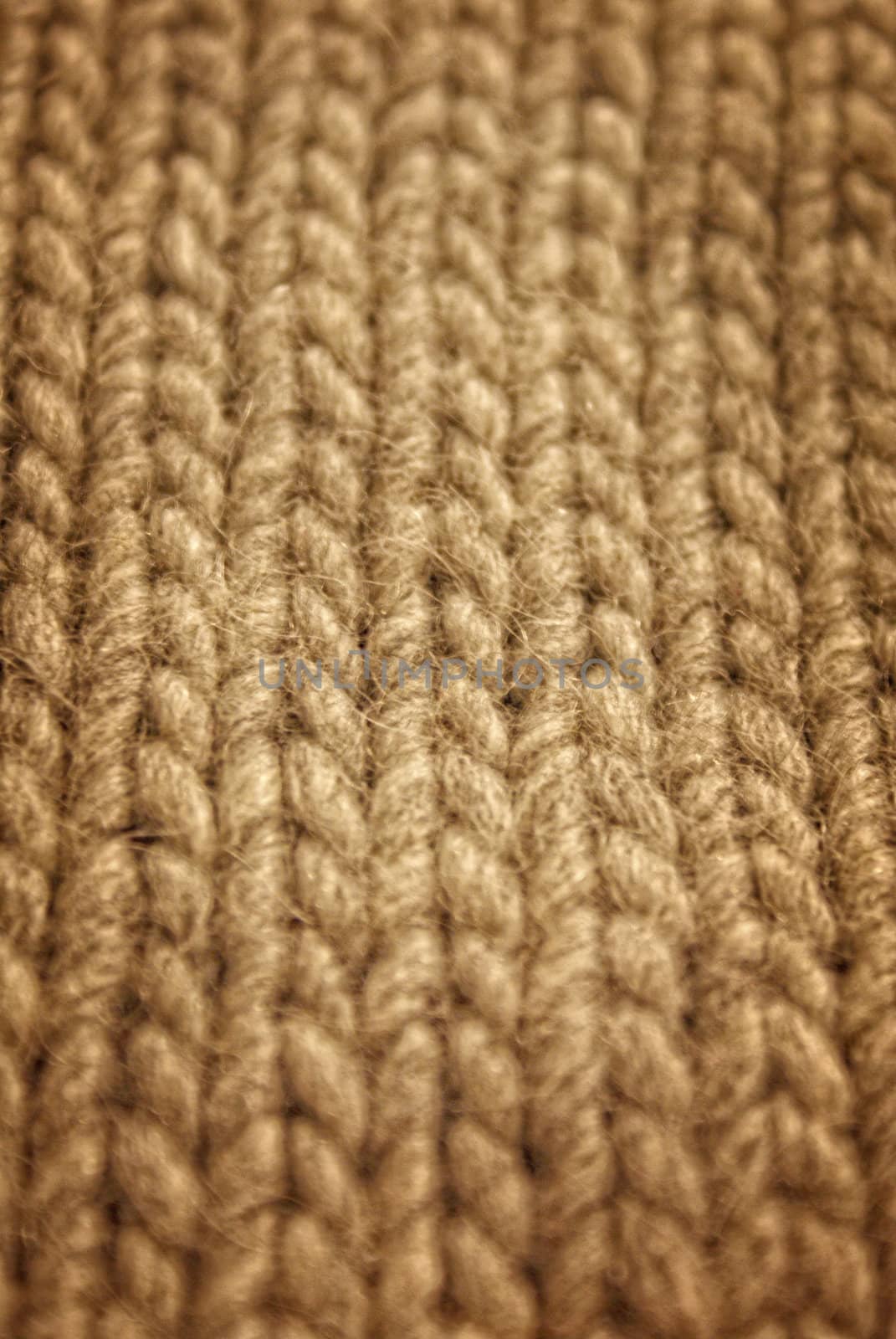 gray background of hand-knitted wool scarf