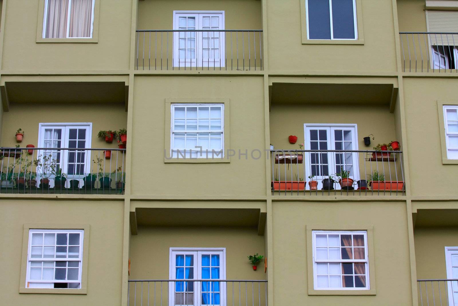 Big apartment building with small square unites and balconies