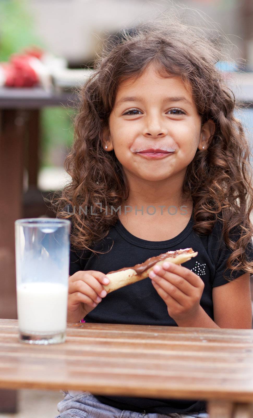 Smiling girl snacking by TristanBM