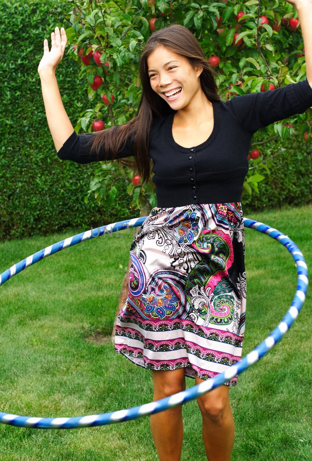 Hula hoop. Beautiful Beautiful mixed race chinese / caucasian woman doing hula hoop outdoors in the fall