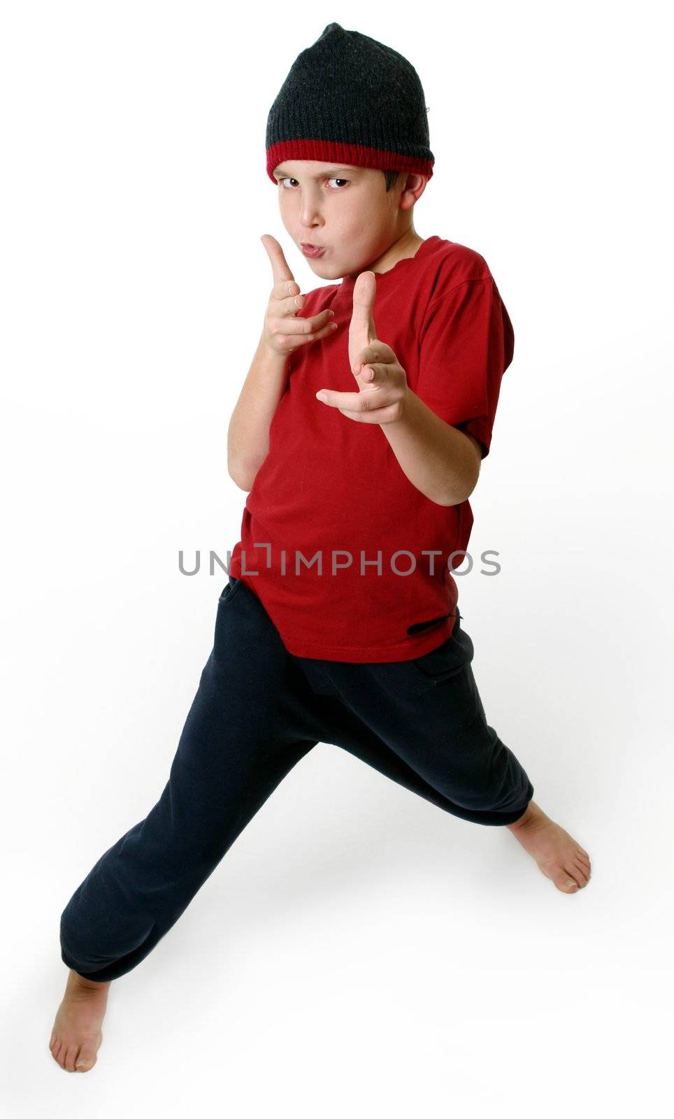 Expressive boy in casual clothes standing barefoot on a white background