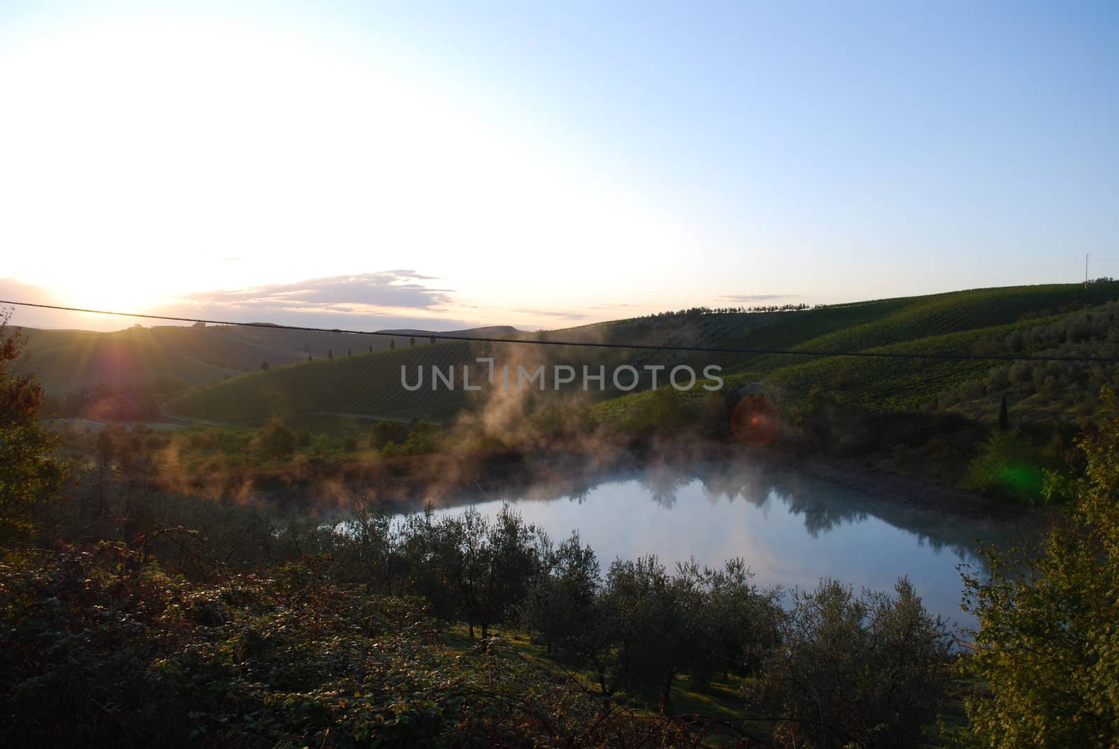 Topycal Tuscan landscape with hills, vineyards, cypresses during the autumn