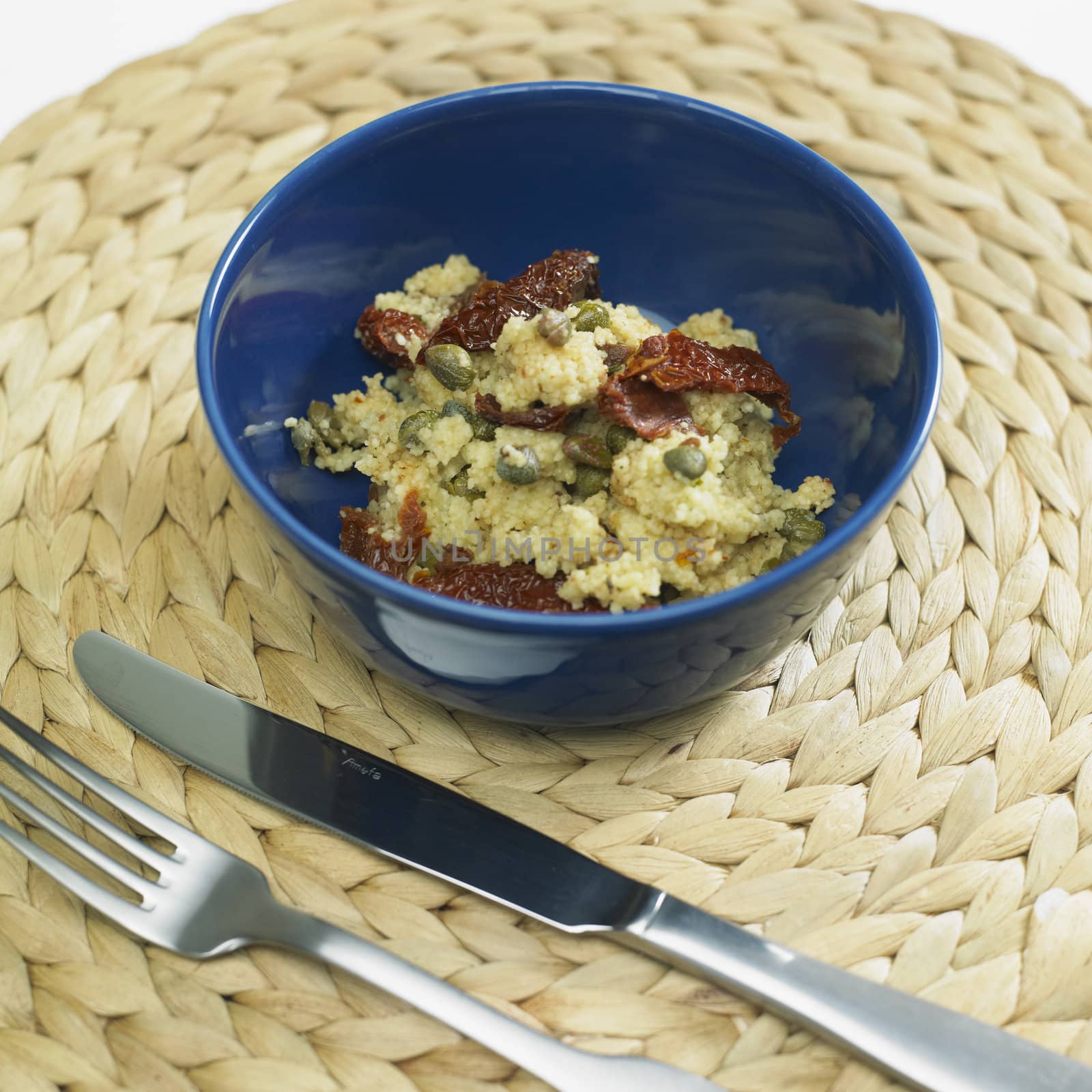 warm couscous salad with dried tomatoes and capers