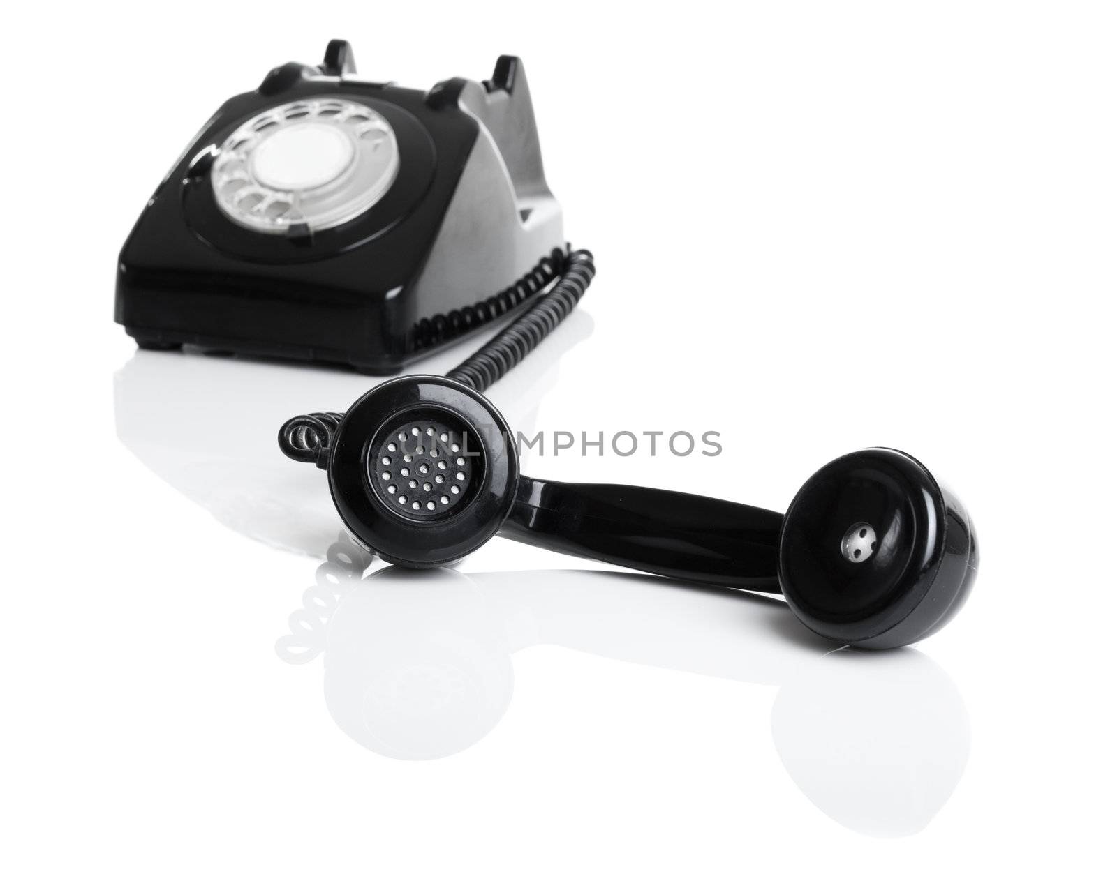 Nice vintage telephone perfectly isolated on white background, focus is on the handset