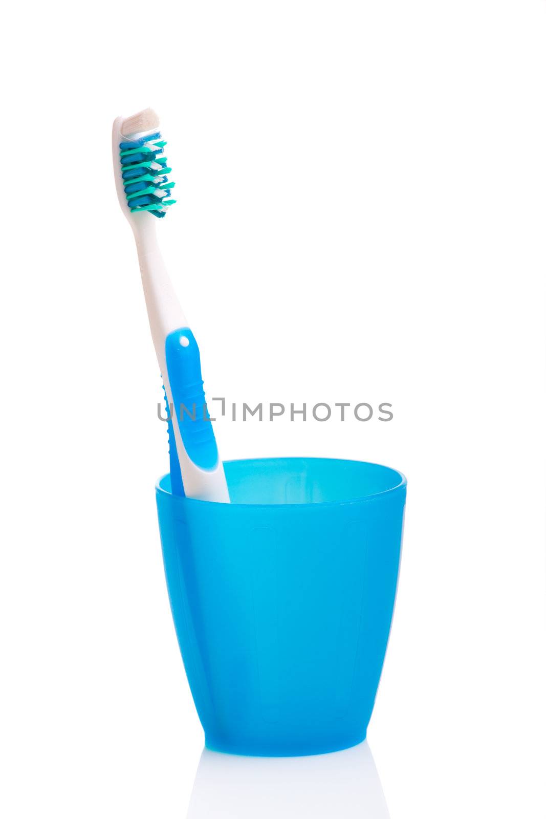 Hygiene objects, toothbrush on a cup isolated on white background