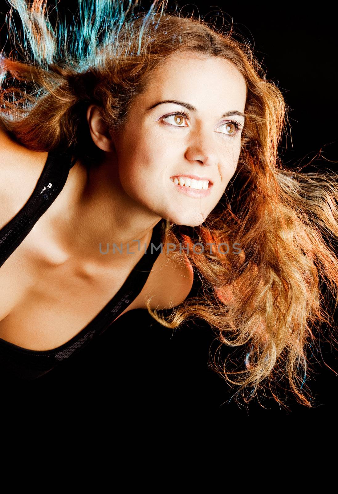 Studio portrait of a young fashion woman posing on a black background