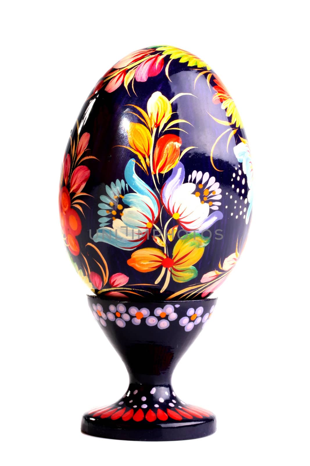 Wooden painted egg in style of Russian varnish list on a support. On egg flowers a symbol of the Russian village are drawn.