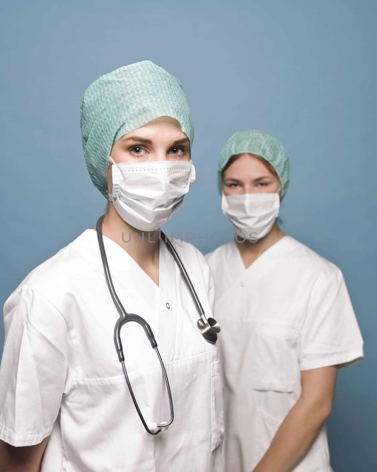 Two nurses with surgical masks and a stethoscope