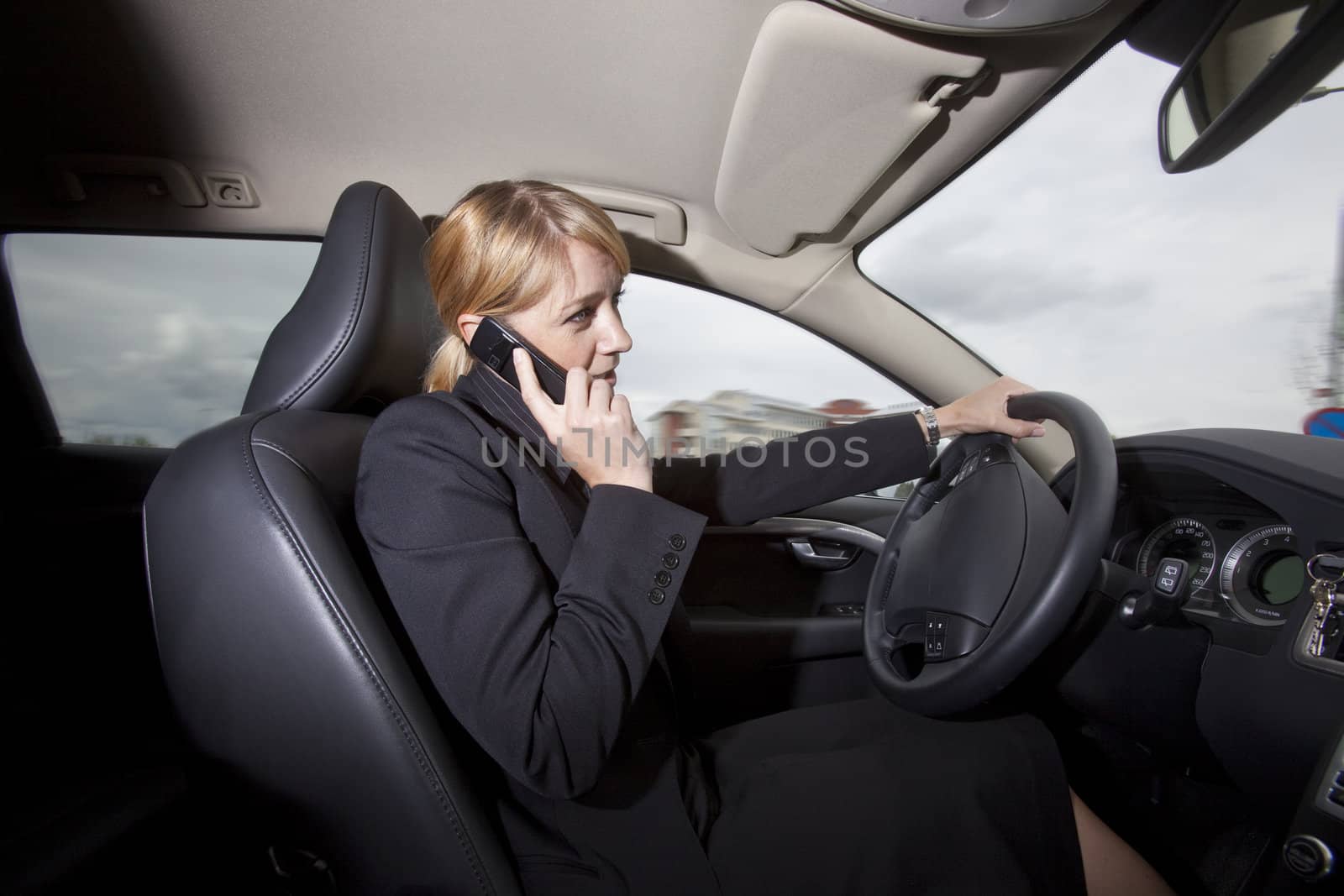 Woman on the phone when she driving her car by gemenacom