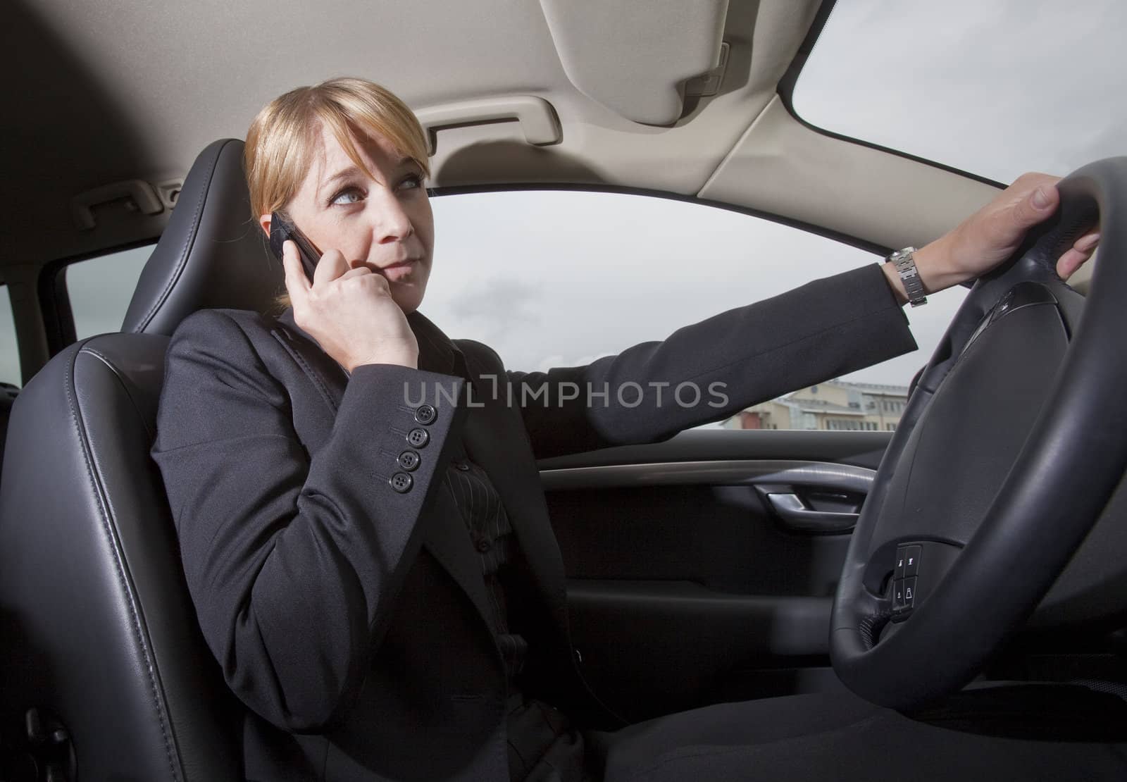 Woman on the phone when she driving in her car