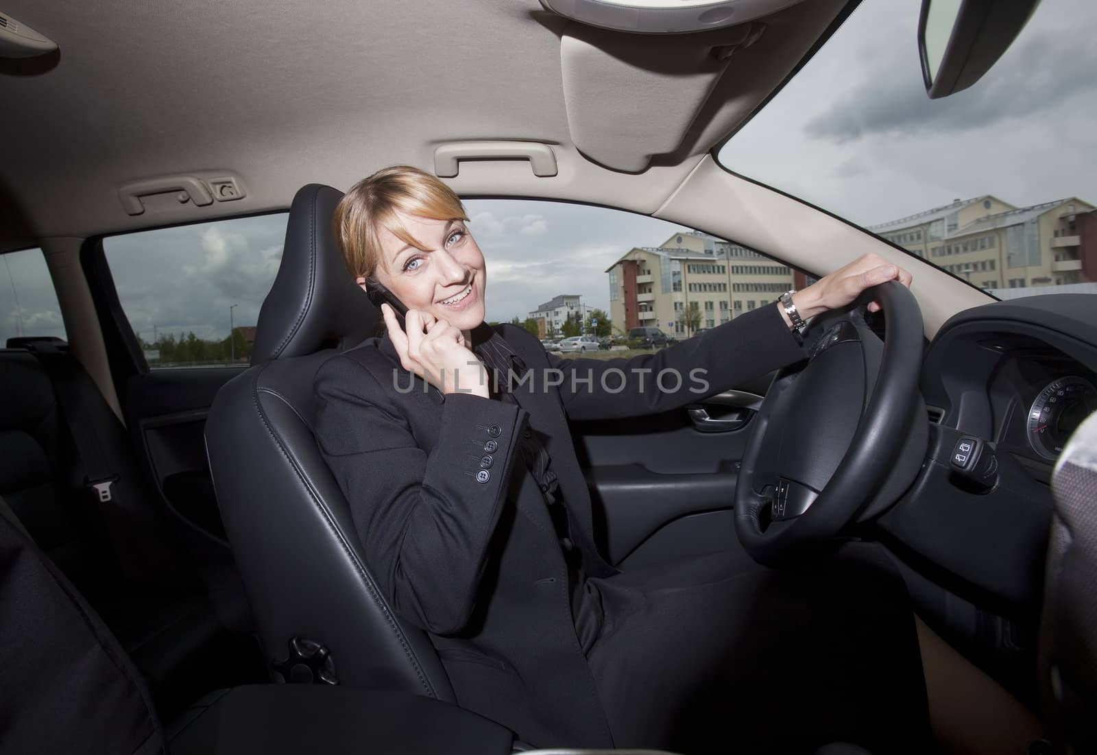 Woman on the phone when she driving in her car by gemenacom