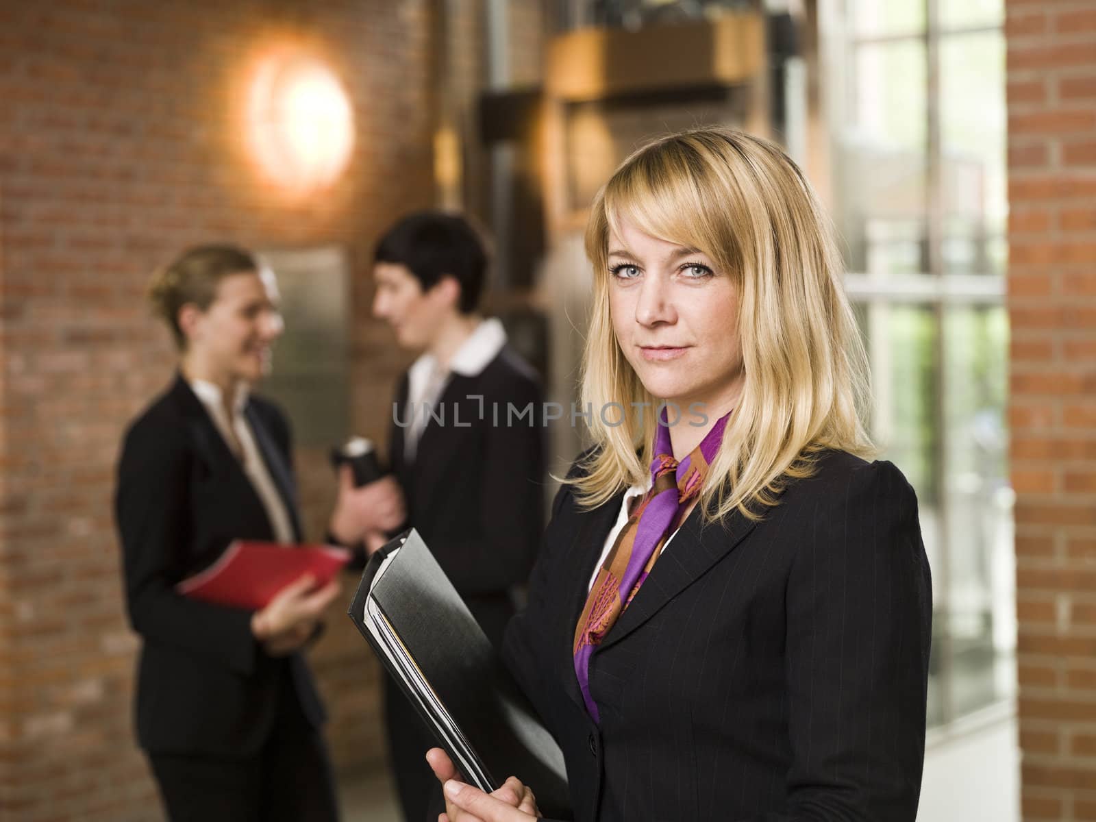 Businesswoman in front of two women