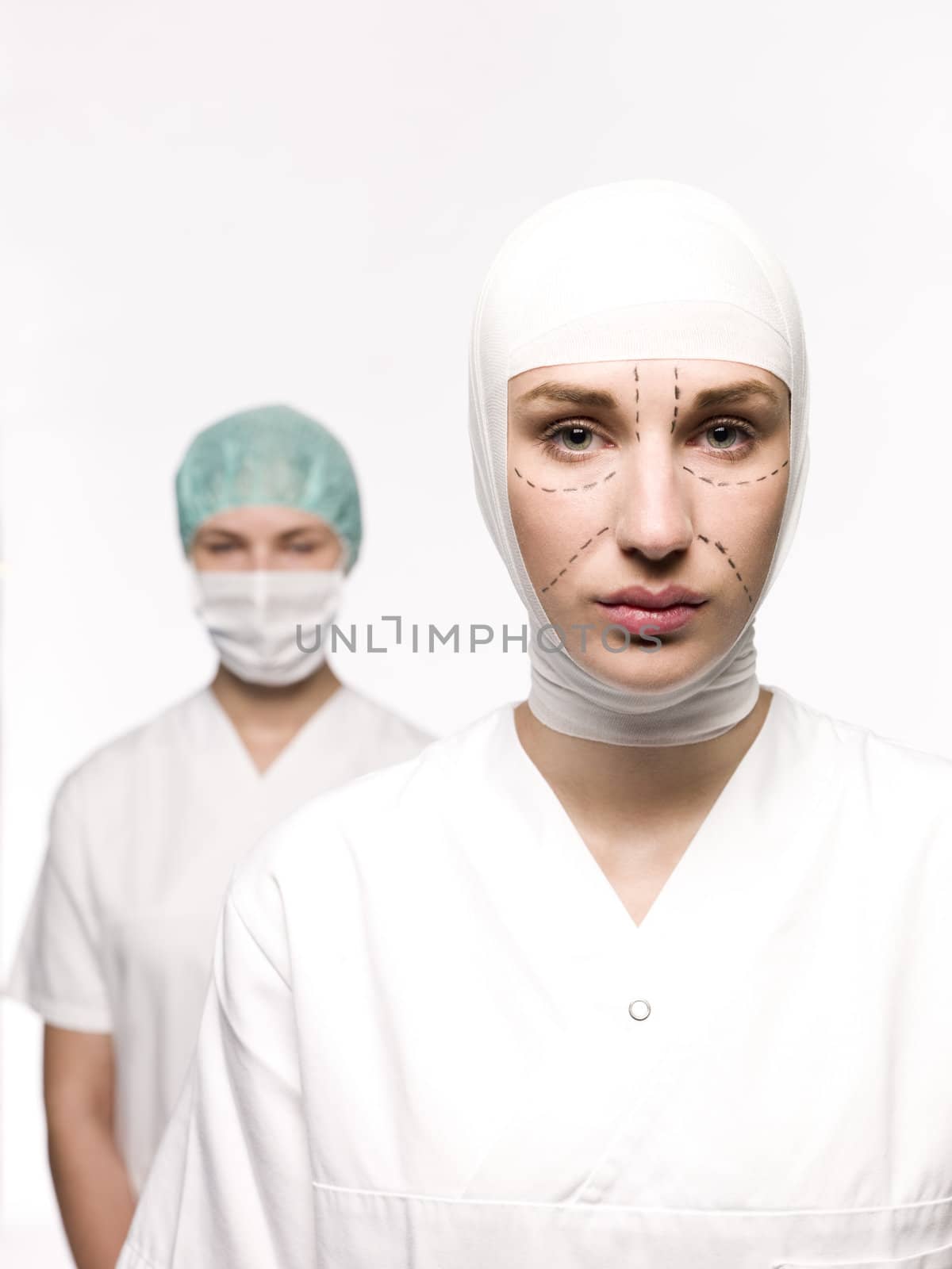 Woman prepared for plastic surgery with a nurse at her back