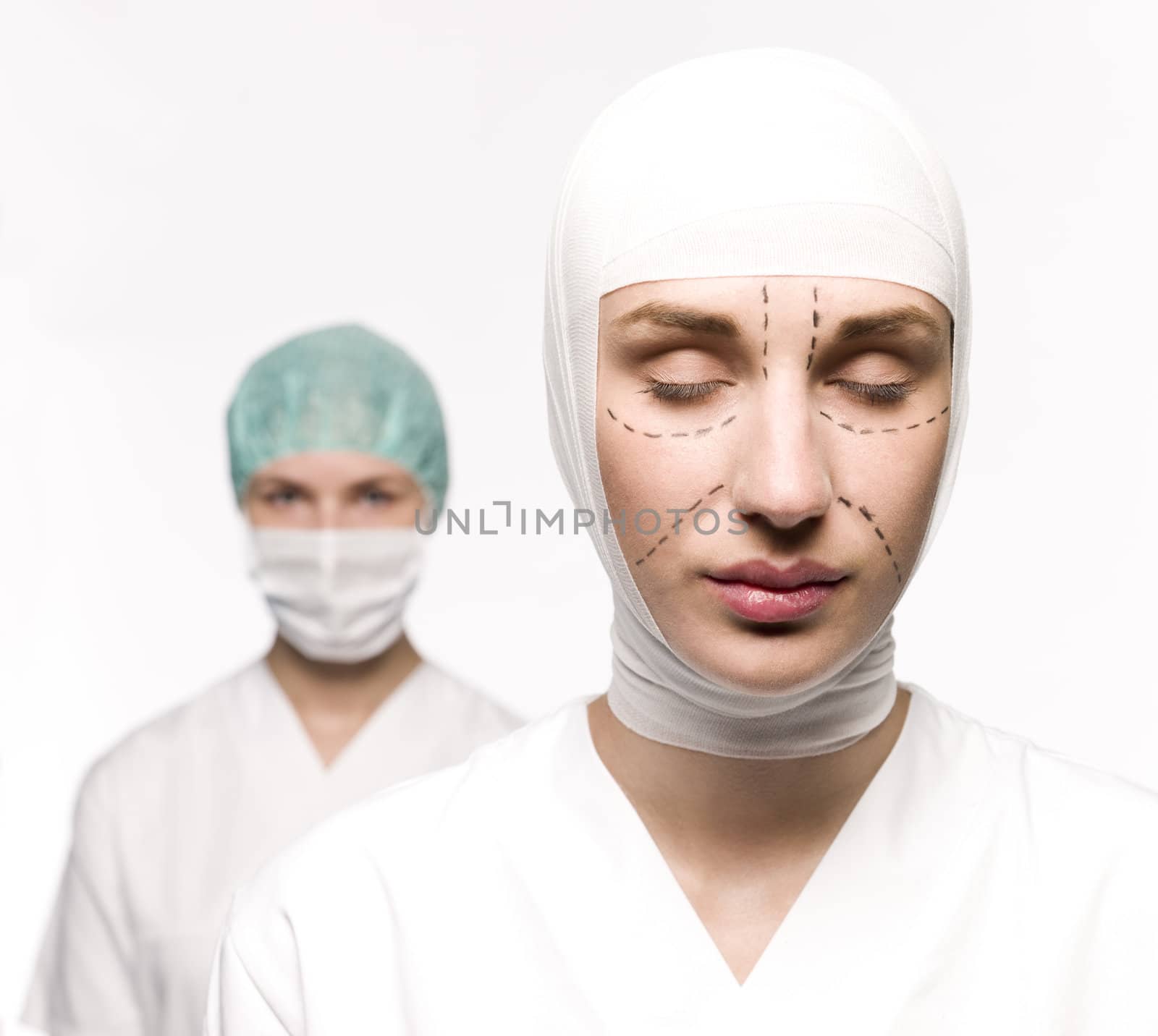 Woman prepared for plastic surgery with a nurse at her back